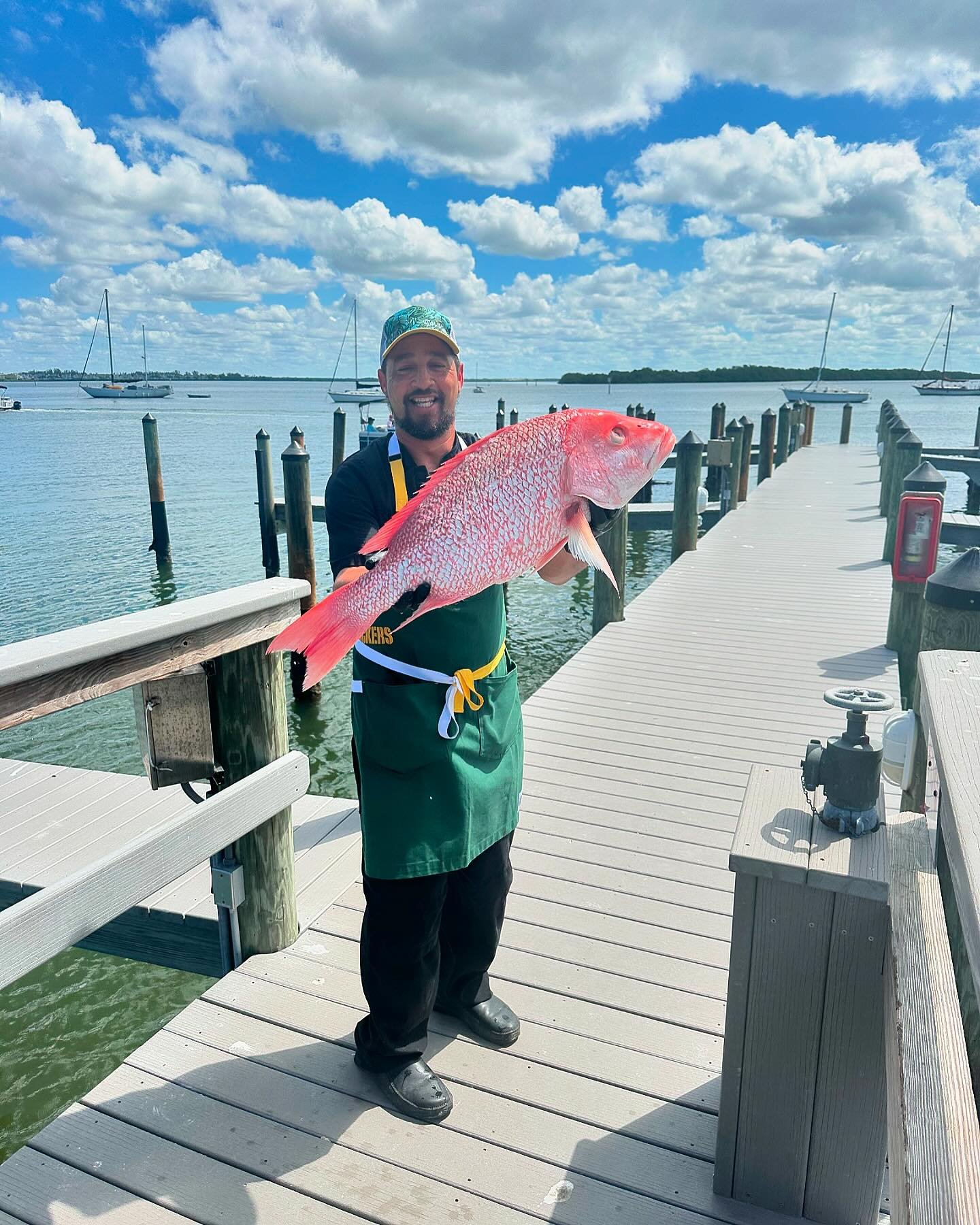 🎣👨&zwj;🍳 Check out Chef Mike not only showcasing a beautiful fresh Red Snapper but also sporting his new Green Bay Packers apron! 💚💛 Even though we&rsquo;re Tampa Bay Buccaneers fans at heart ❤️🏴&zwj;☠️, we can&rsquo;t help but cheer him on and