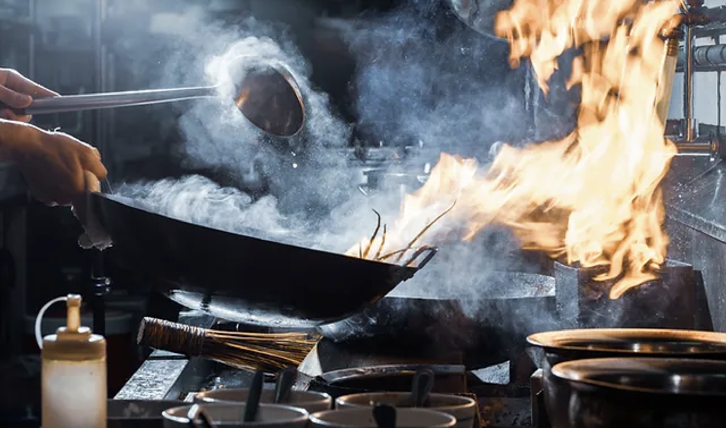 Chef cooking with a wok, fire and steam rising, kitchen utensils nearby.
