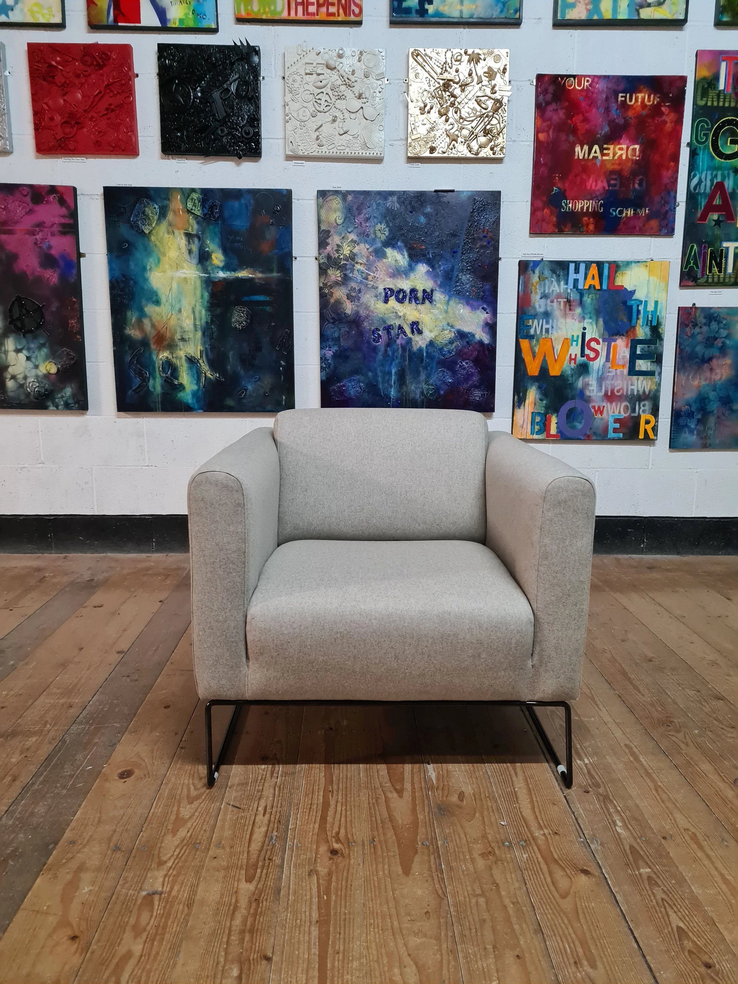 grey reupholstered armchair