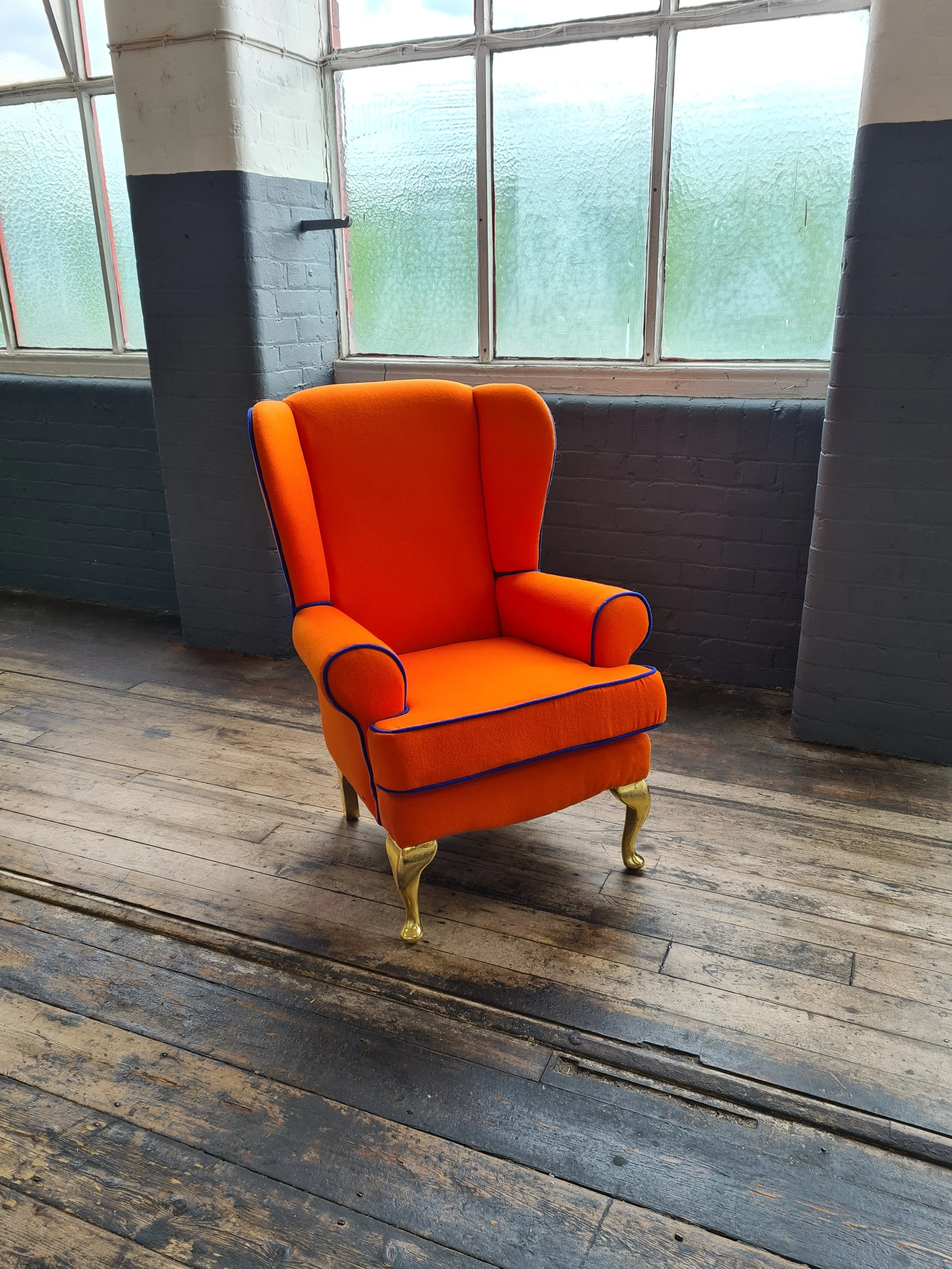 bright orange reupholstered wingback chair