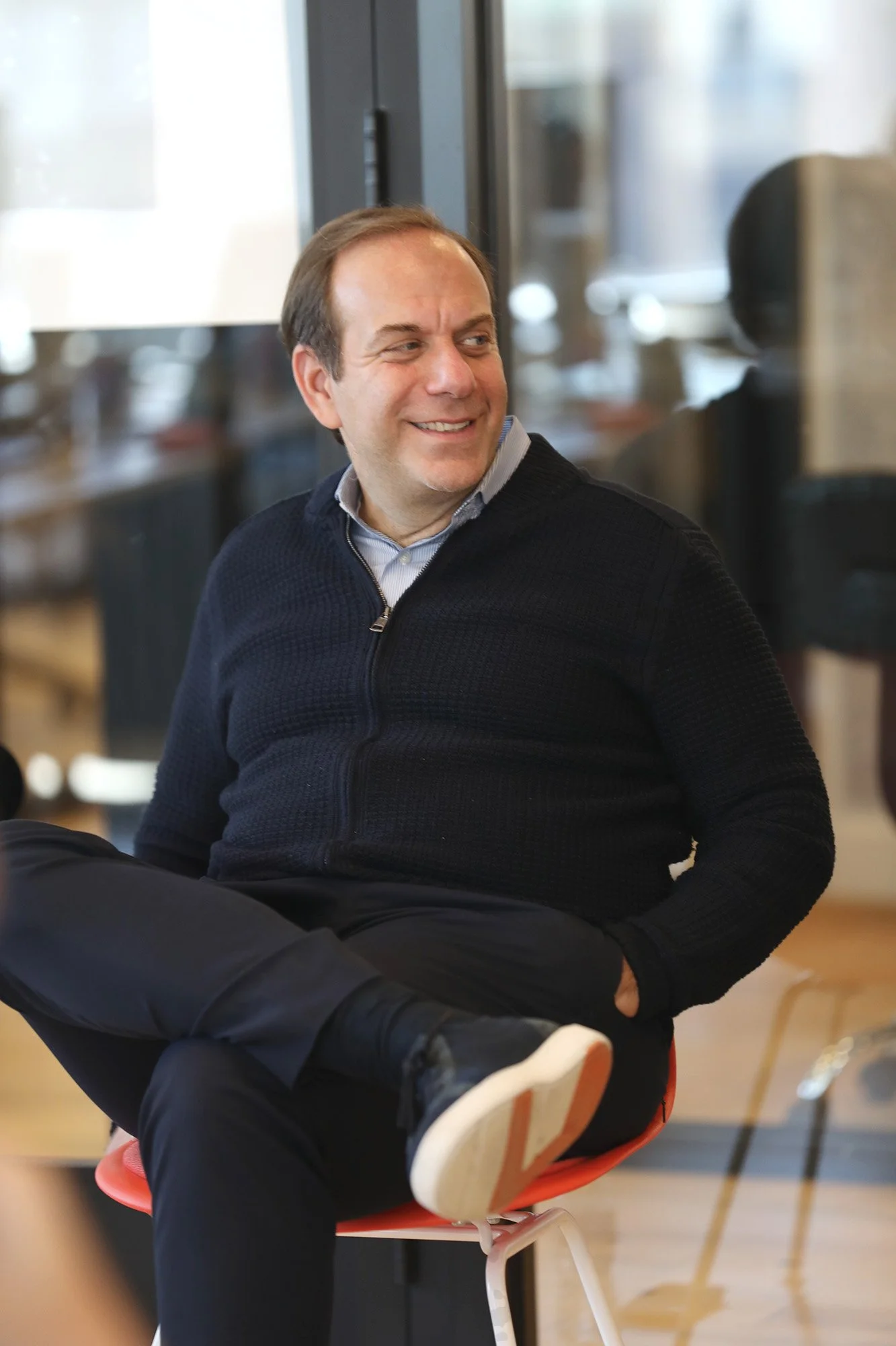 Photo of a man sitting in a chair.