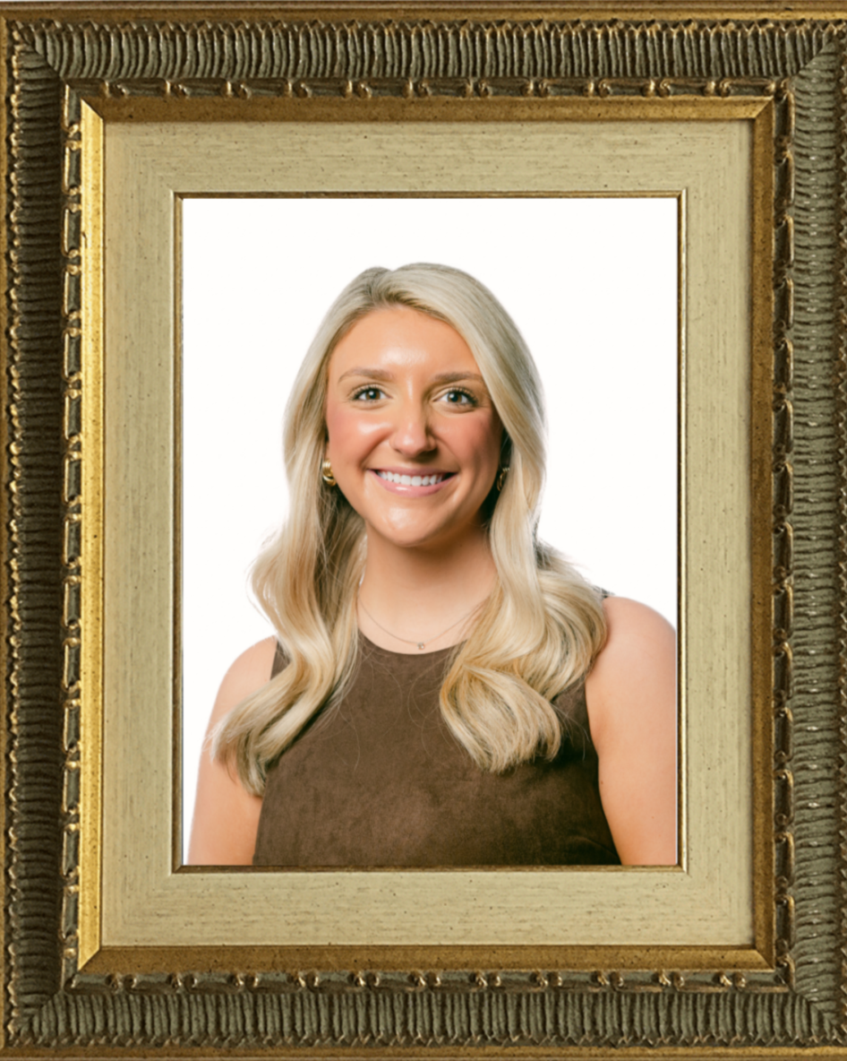 Framed portrait of Mary Price Duncan with blonde hair wearing a brown top standing against a plain background.