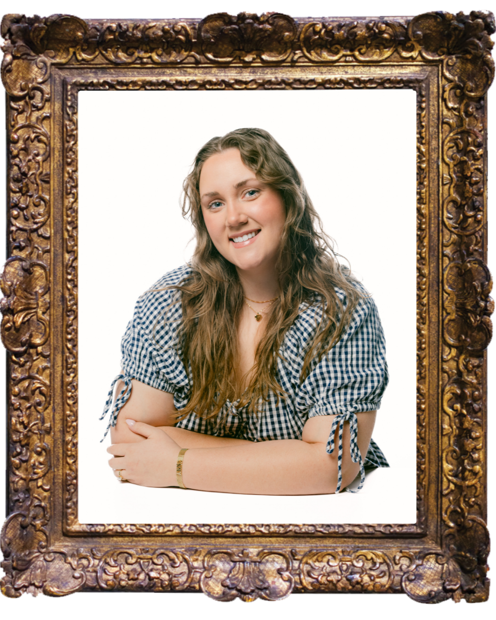 Framed portrait of Anna Mock wearing a black and white checkered blouse sitting against a plain background.