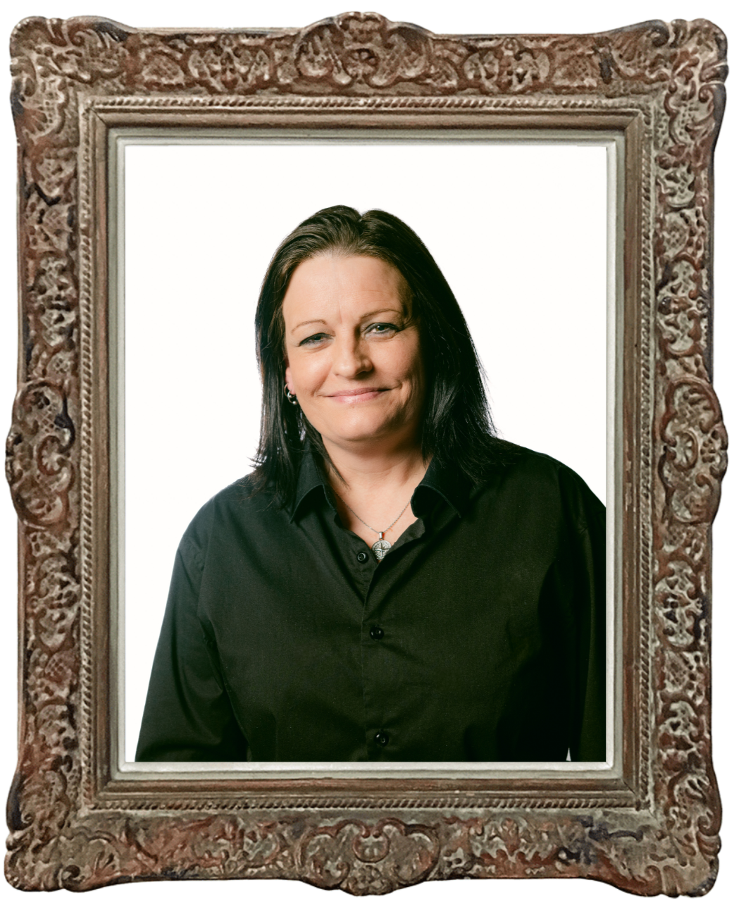 Framed portrait of Carrie Lambert with short black hair wearing a black blouse and standing against a plain backdrop.