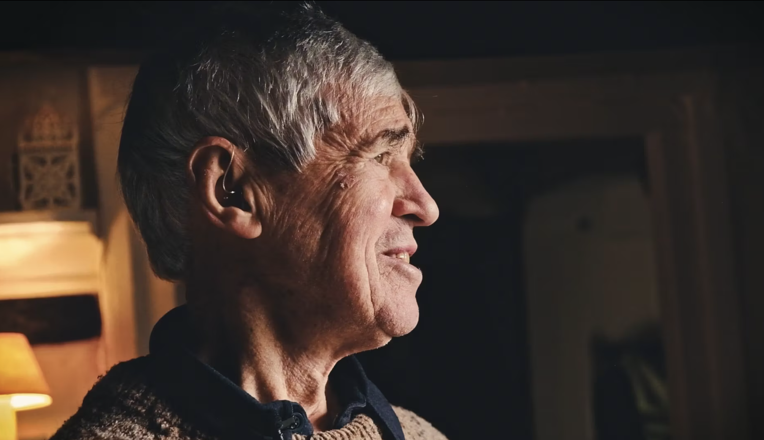 Older man with hearing aid gazing thoughtfully, social impact storytelling campaign for Little Green Energy Company by STORO