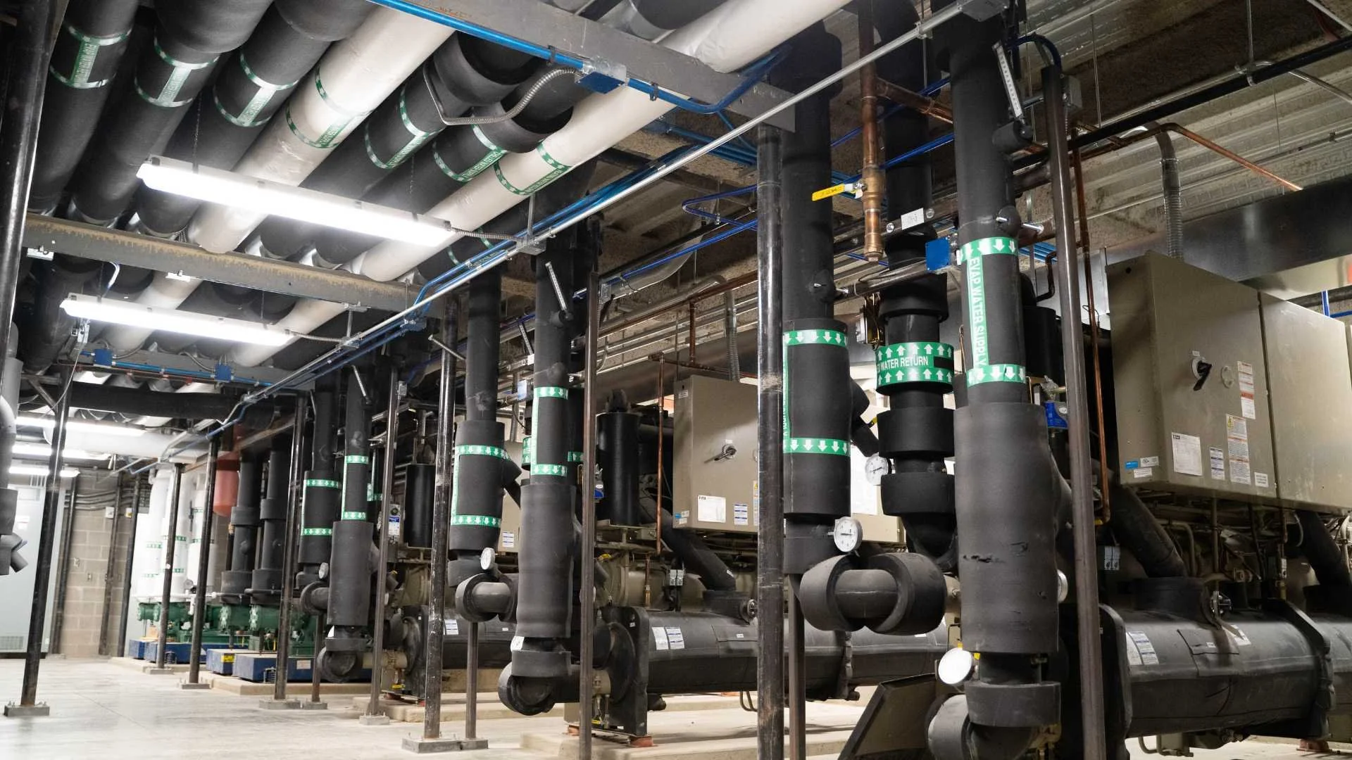 Insulated piping and mechanical equipment in a commercial mechanical room designed to reduce winter heat loss and improve energy efficiency