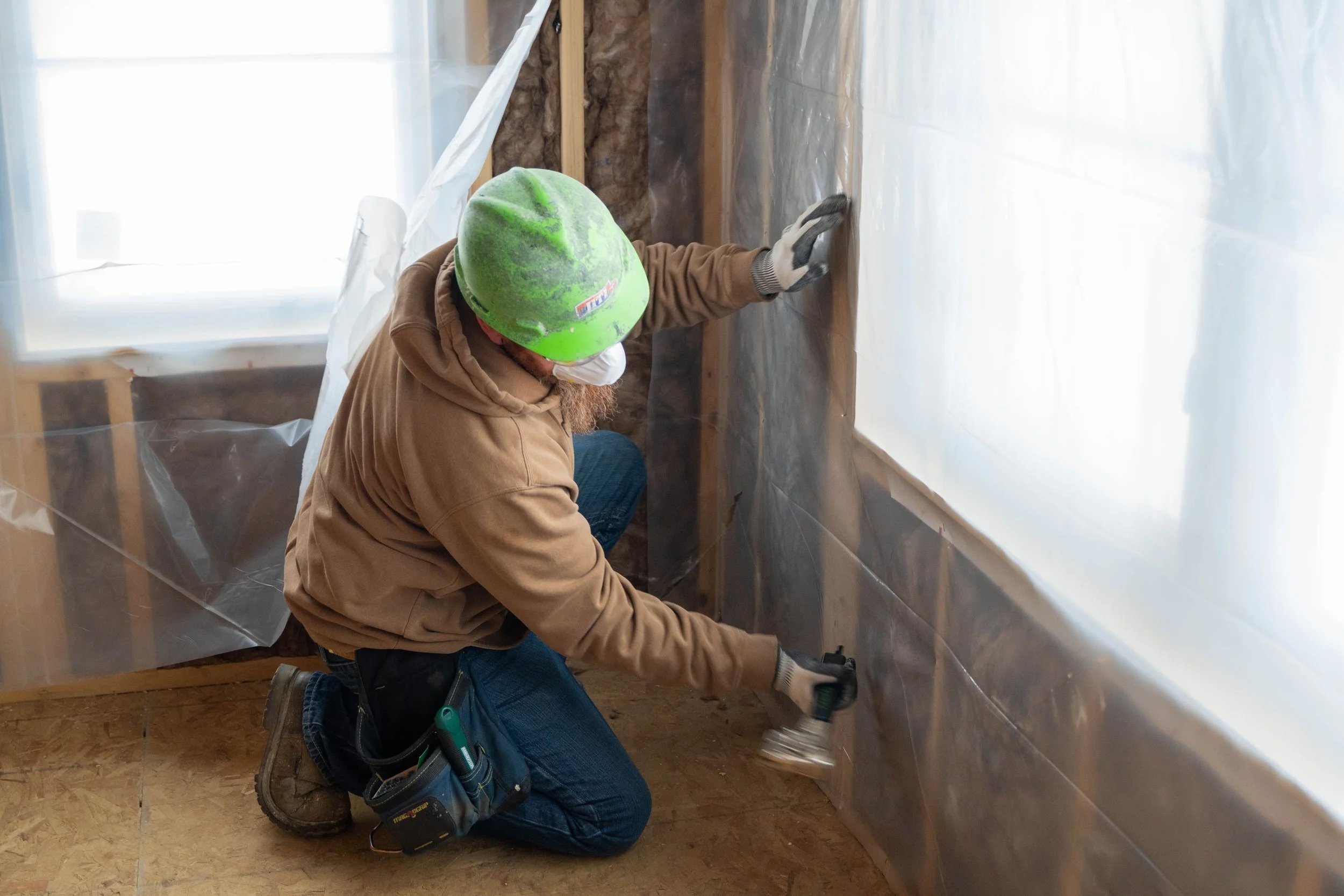 IITI Group Building Systems Insulation Installer working on a job site