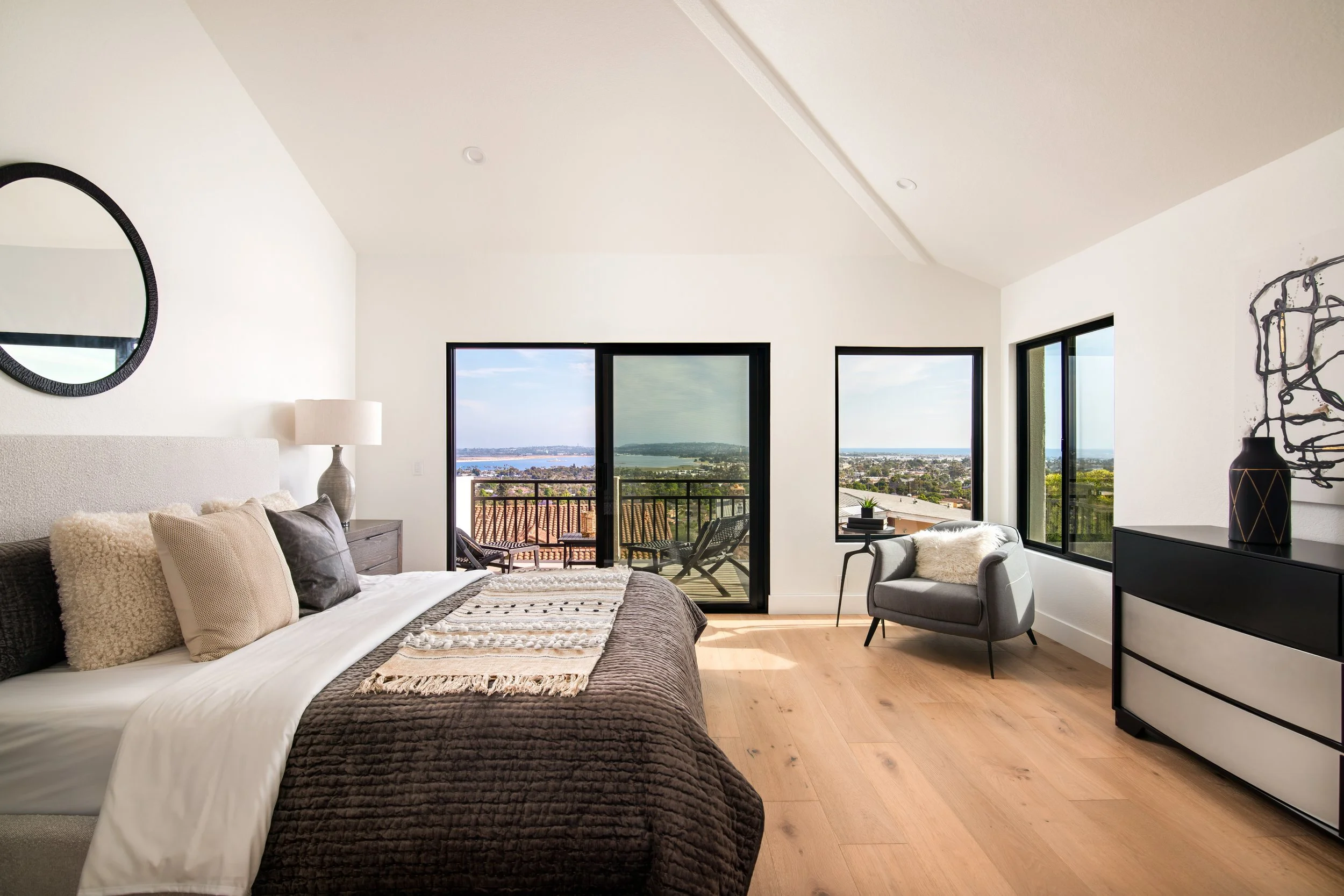 Contemporary primary bedroom furniture art and accessories.  Point Loma staged home. 