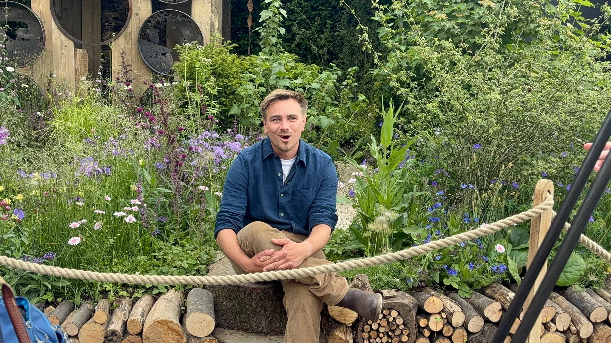 Horticulturist Jamie Butterworth talking about plants while sitting in a garden