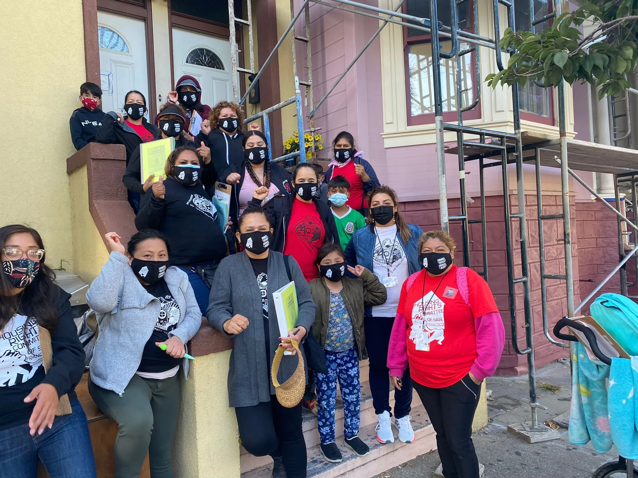Snow-capped mountains with cloudy sky and grassy hills in the foreground.
