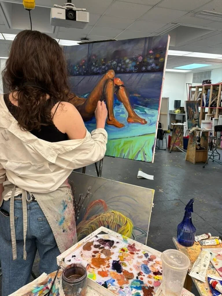 Eryn painting at easle