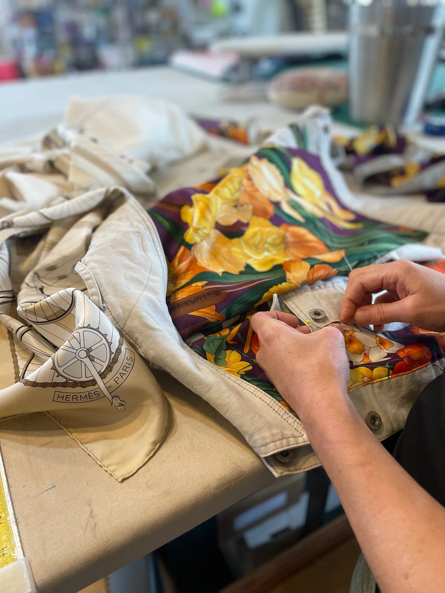 Seamstress close up pinning jacket