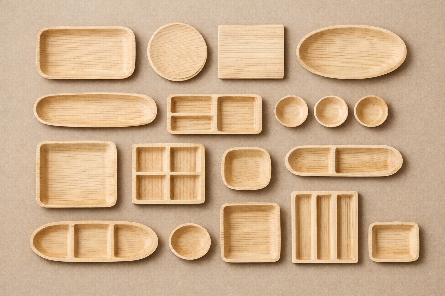 Various empty areca trays and bowls arranged on a beige surface.