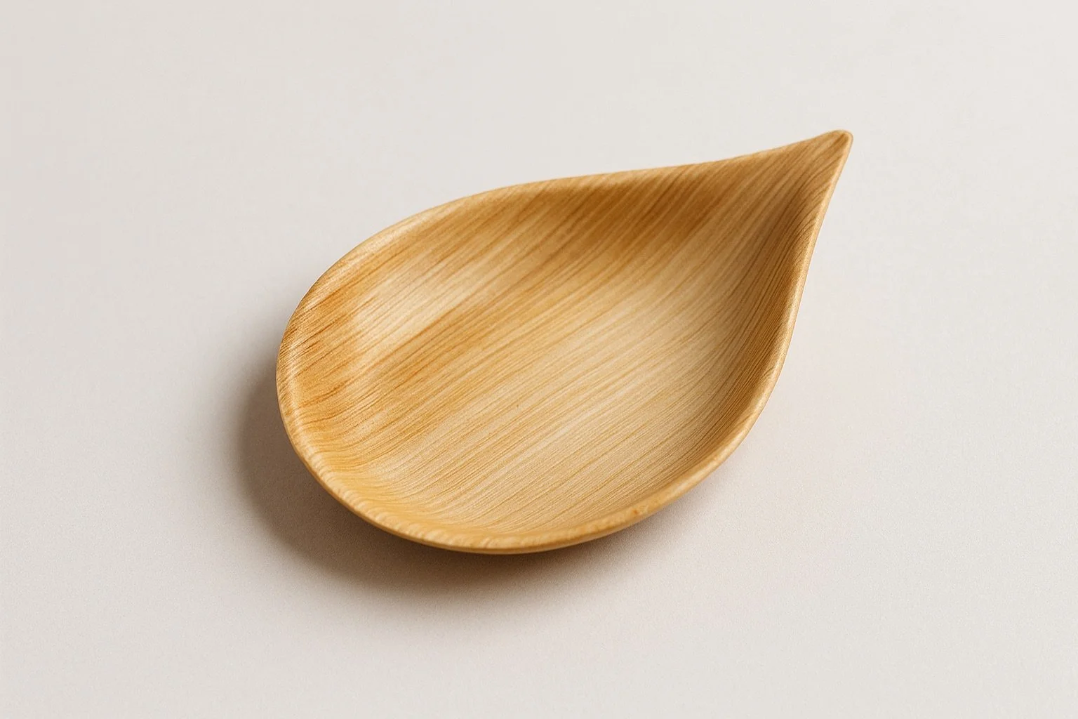 A areca spoon with a smooth finish on a plain white background.