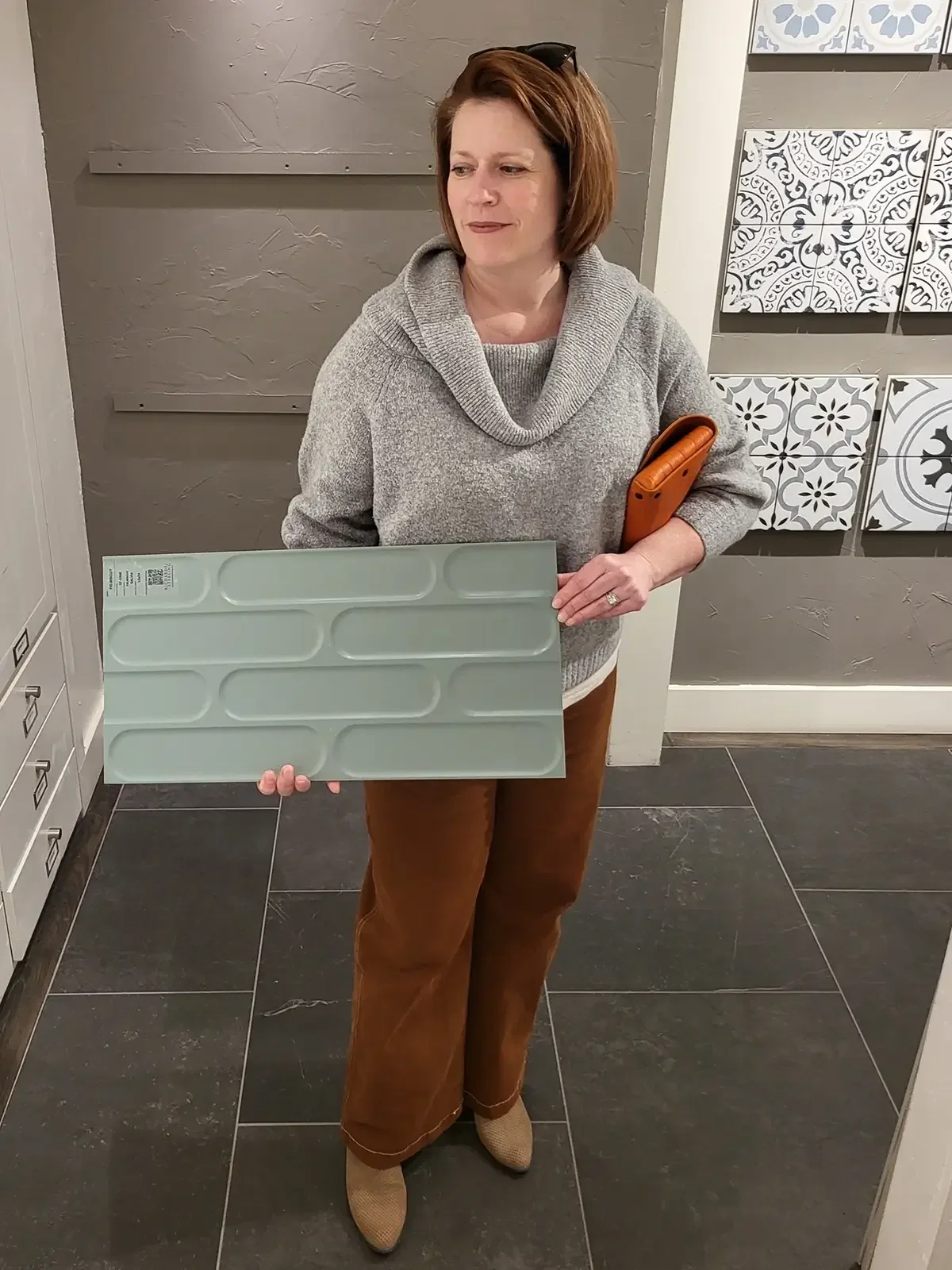 Kim McEuen, owner of Dickerhoof Design + Build, selecting tile for a remodel