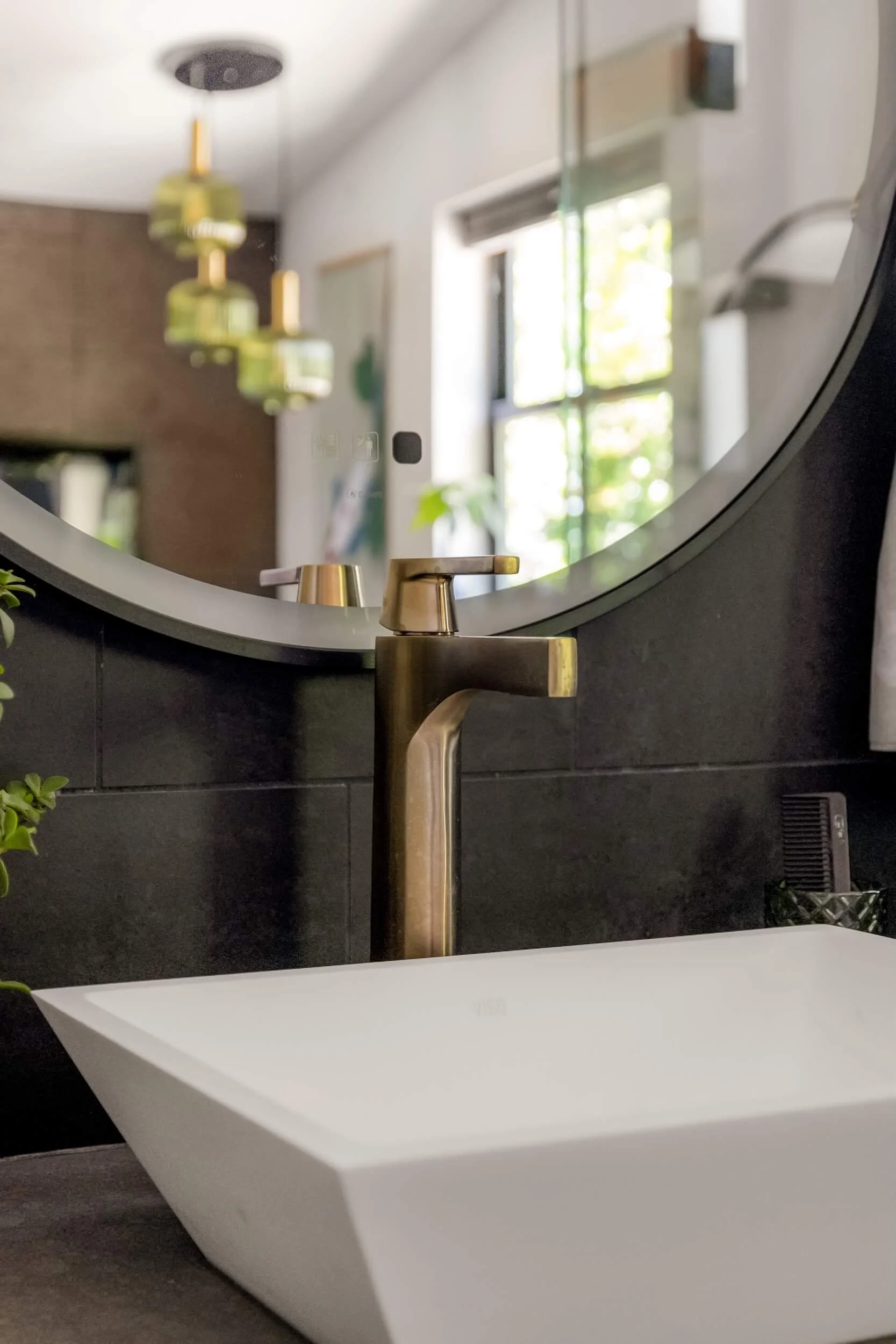 Round mirror above modern vanity