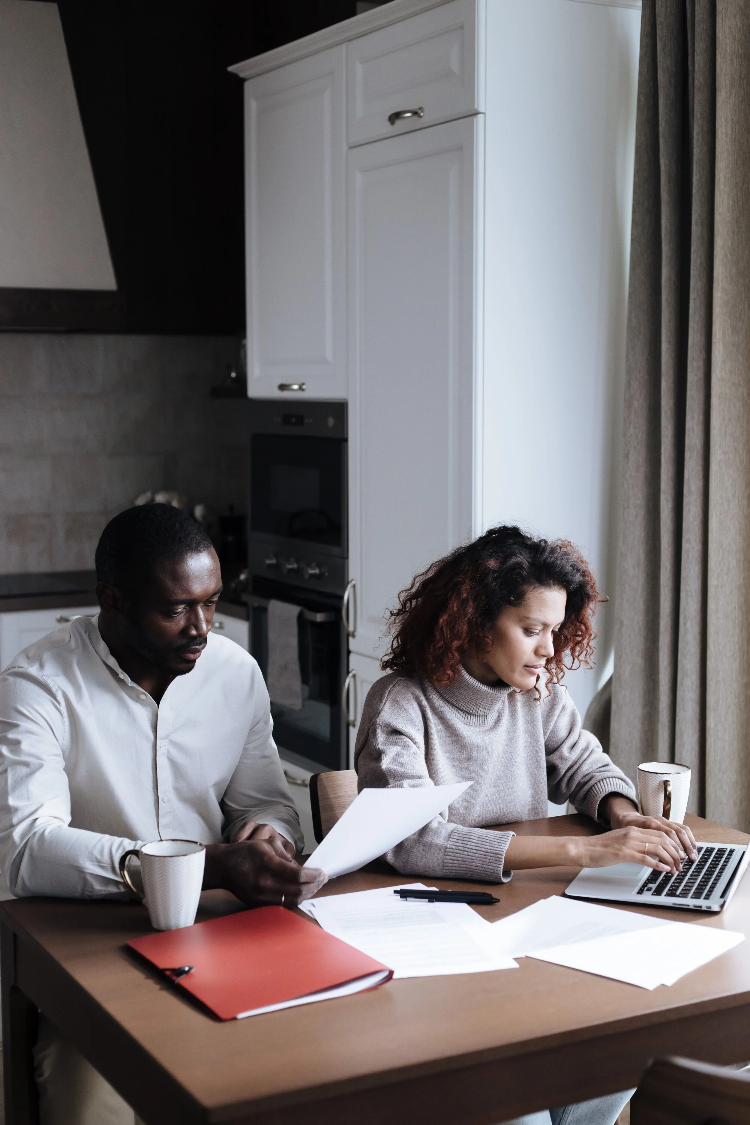Engaged couple working through premarital counseling topics at home in Minnesota