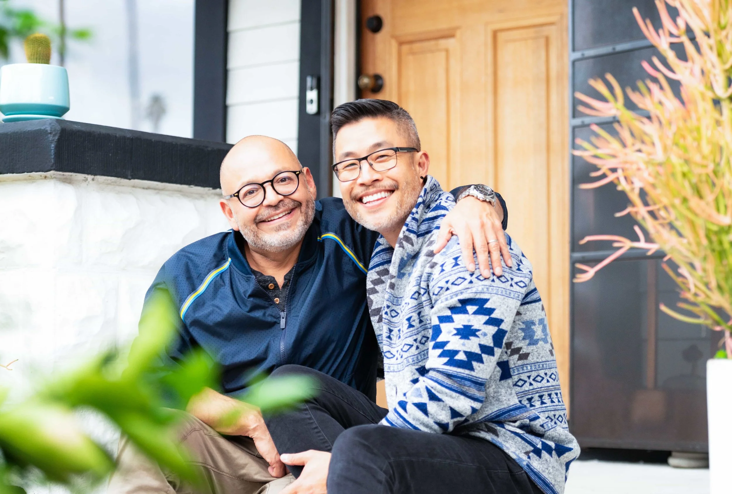 Same sex couple embracing and smiling