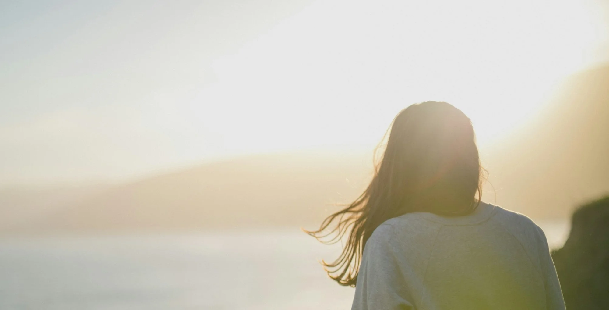 Woman gazing at horizon hopeful about postpartum support specialized perinatal mental health women's issues counseling for women