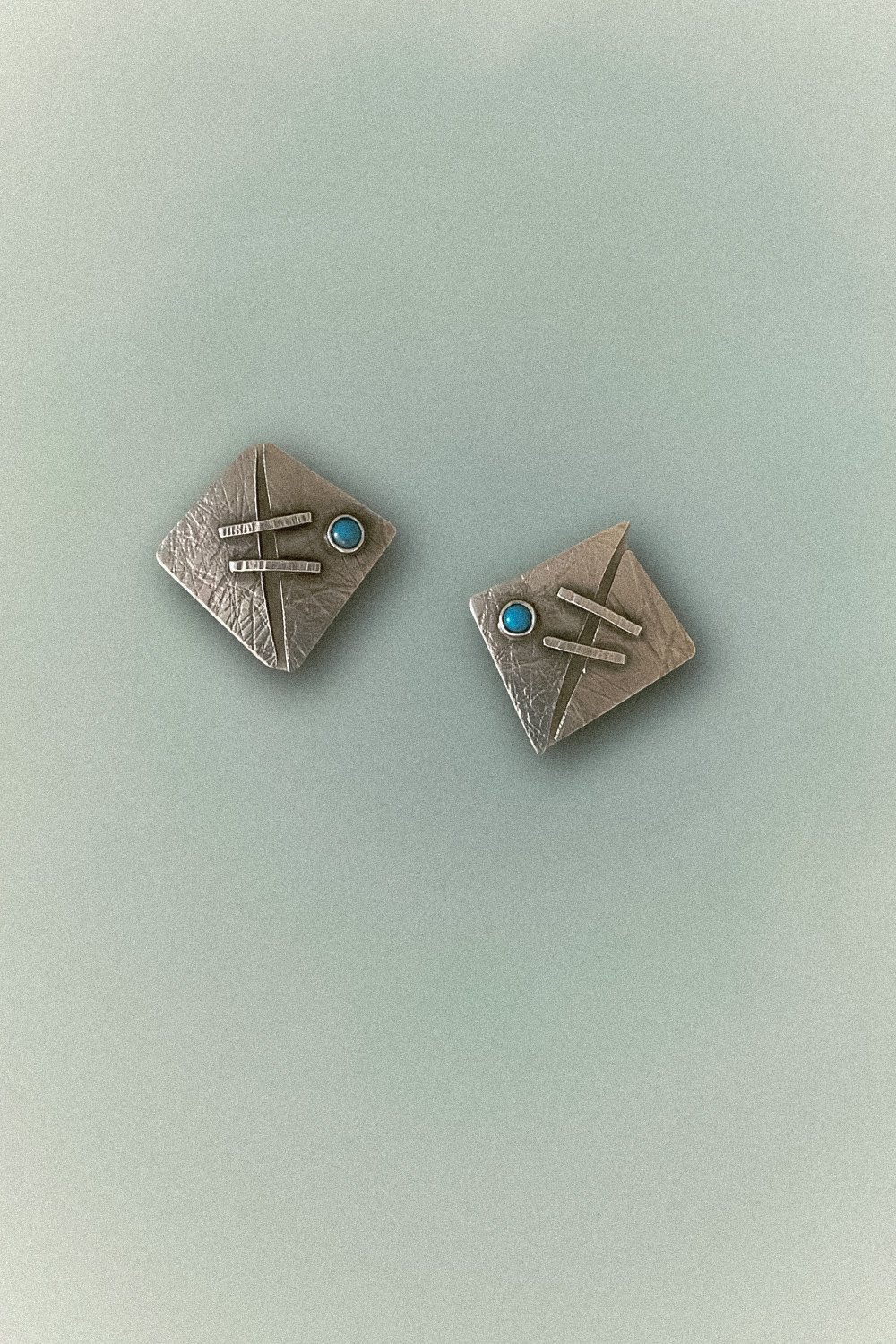 Turquoise Oasis Stud Earrings featuring vibrant turquoise set in textured sterling silver, handcrafted in Linda Lewis's Avila Beach studio