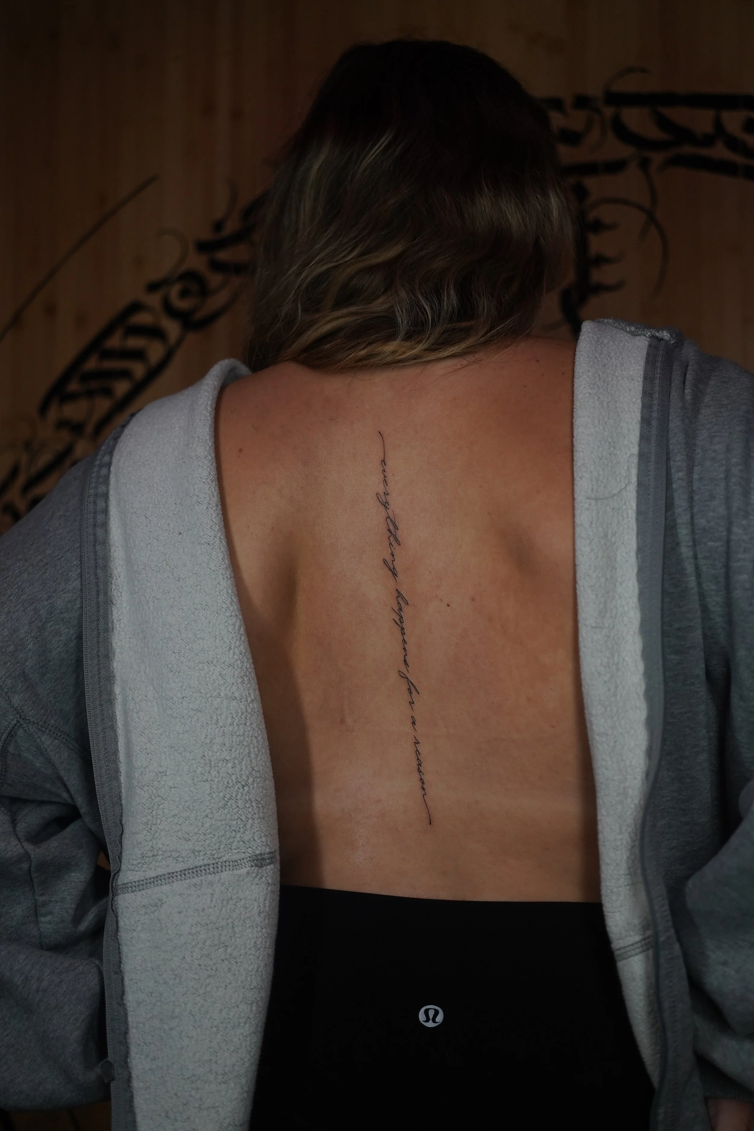 Fine Script Spine Tattoo