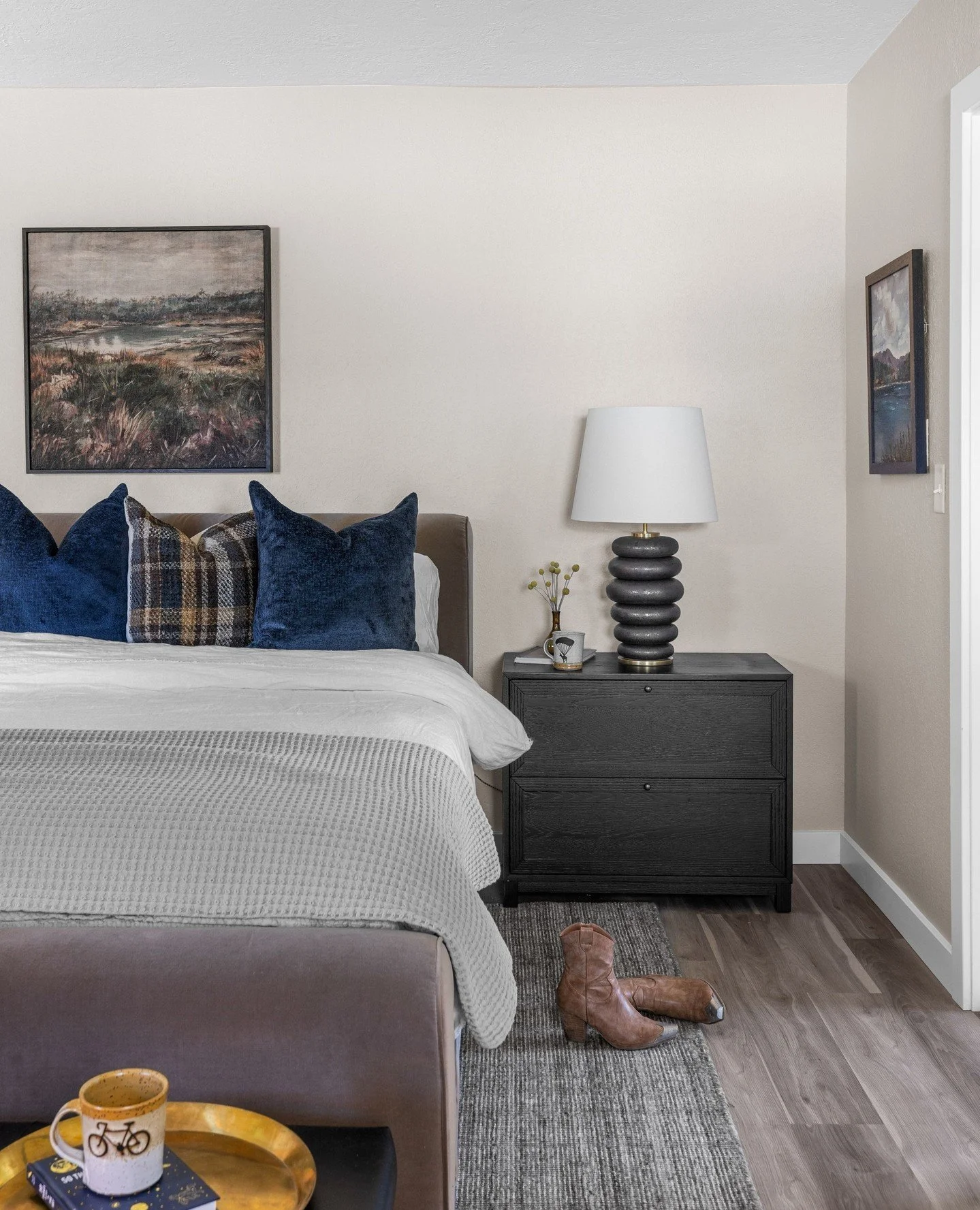 The primary bedroom. A space that strikes just the right balance of masculine and cozy &mdash; grounded textures, a plush bed you&rsquo;ll never want to leave, and a little reading nook made for slow mornings.
