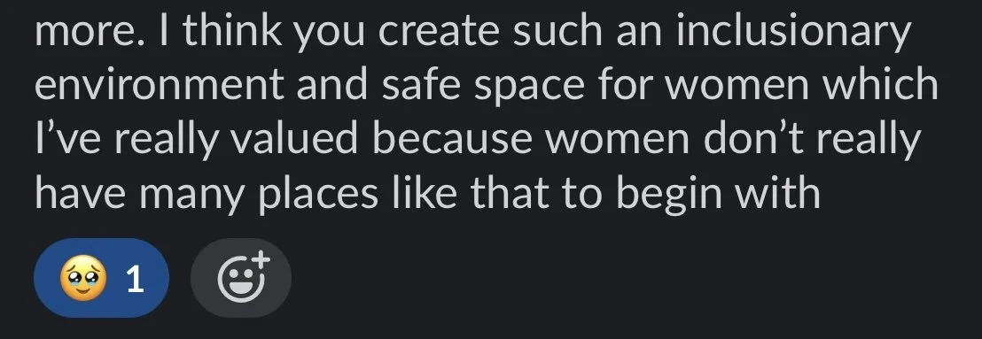 Close-up of a digital screen displaying a text message about creating inclusive and safe environments for women.