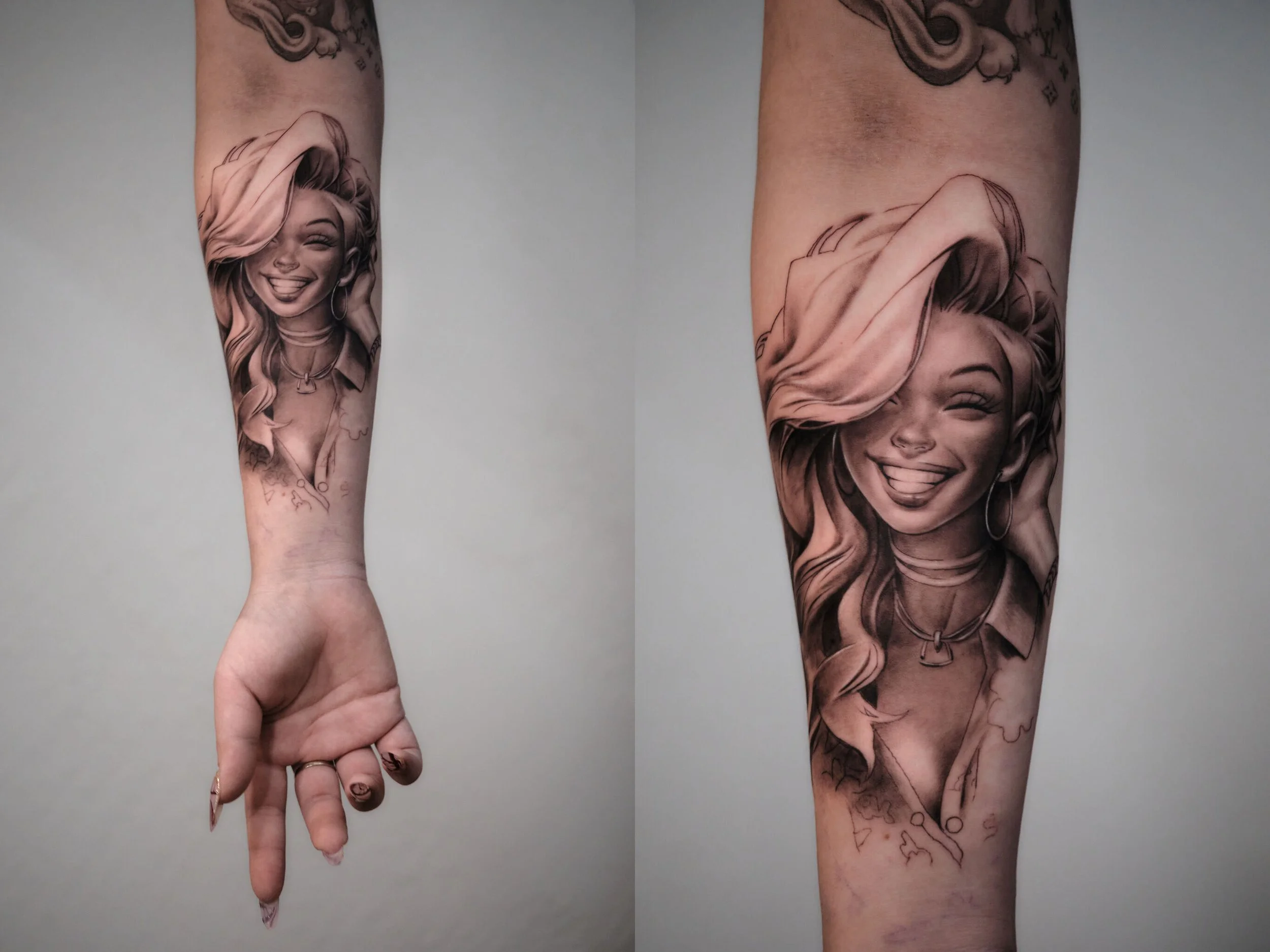 Black and gray tattoo of a woman with long hair, smiling and sticking out her tongue, on a person's forearm.
