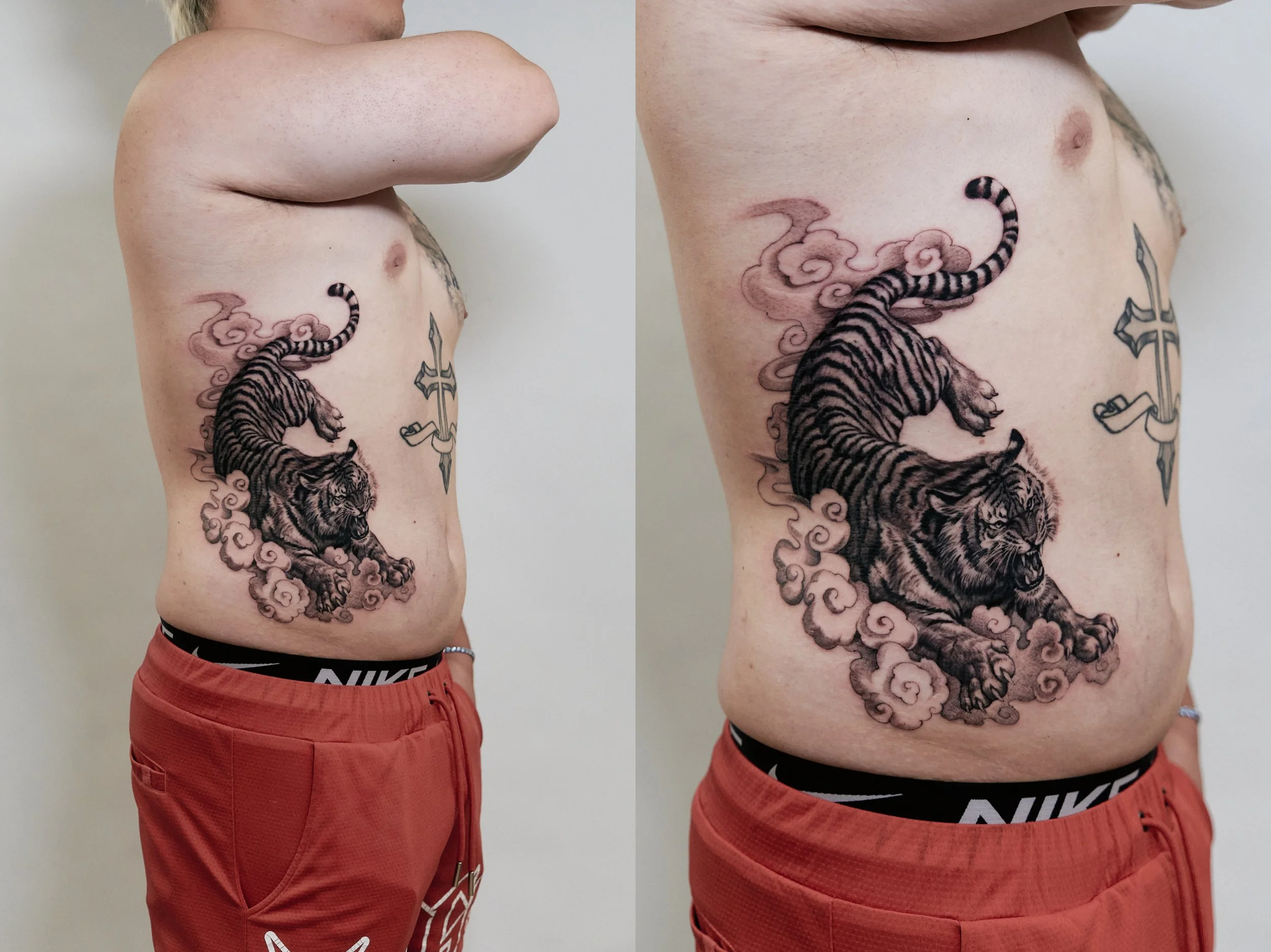 Tattoo of a tiger surrounded by clouds and a sword on a person's side torso.