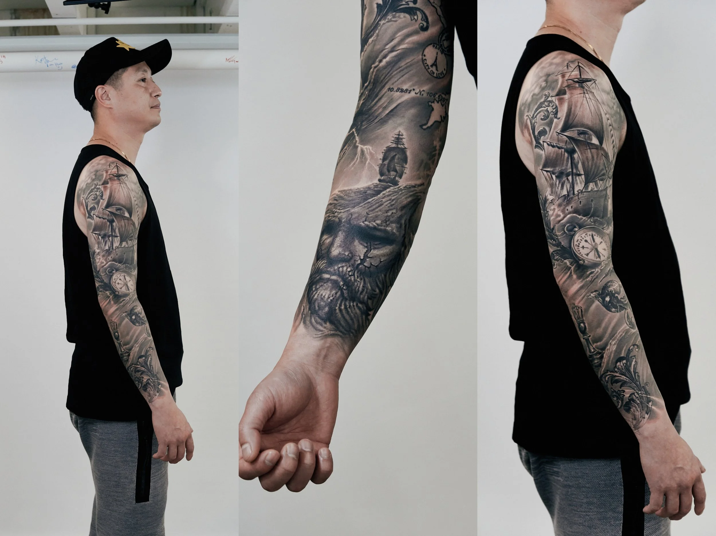 A man with white skin, wearing a black tank top and gray pants, standing in profile with tattoos on his left arm, and a black cap with a yellow star. The tattoos depict a ship, a pocket watch, a skull, and various waves and clouds.