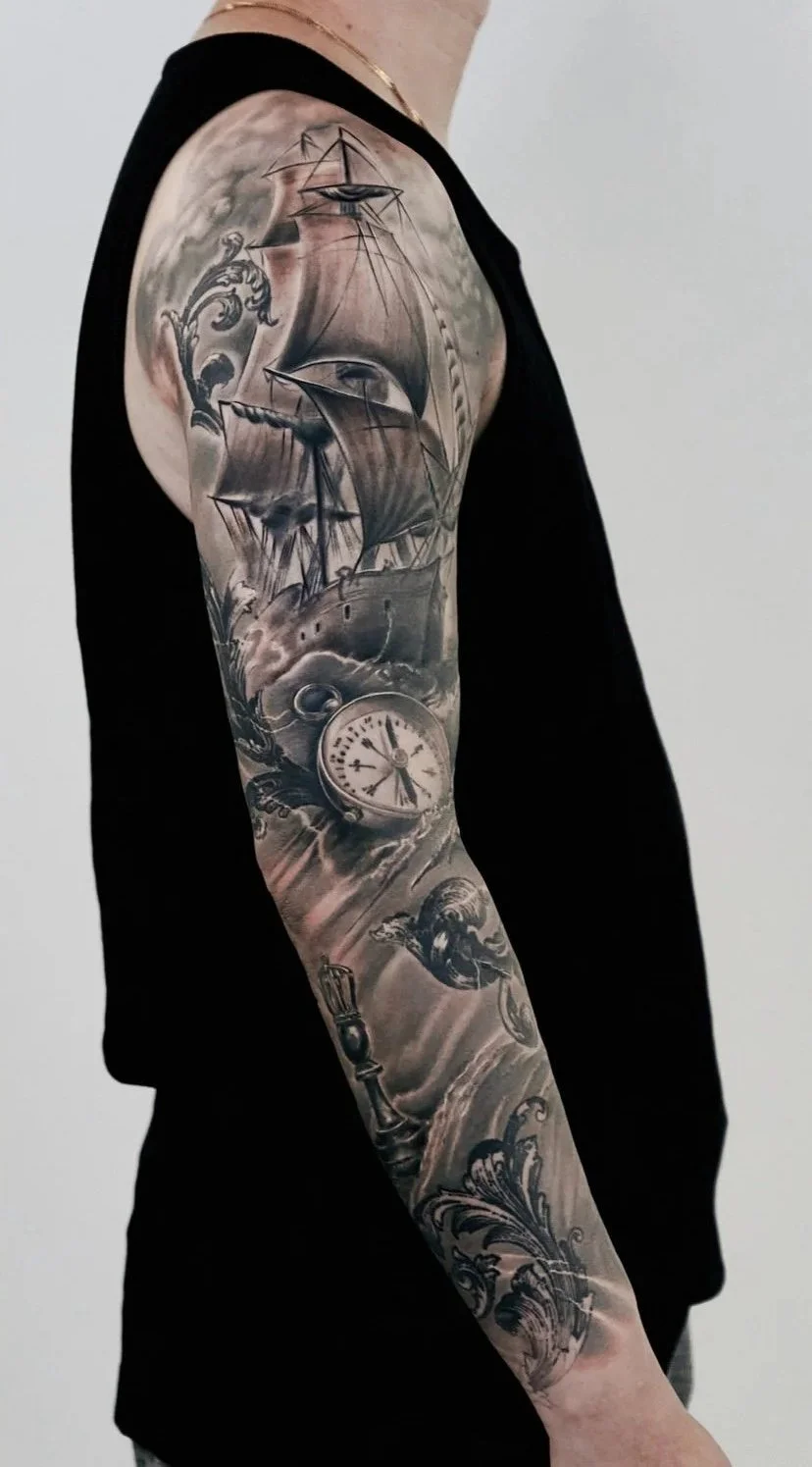 Detailed black and gray tattoo sleeve by Binx at Recycle Tattoo, featuring a traditional sailing ship navigating through crashing waves and a realistic pocket watch. This custom nautical composition showcases smooth transitions and intricate shading 