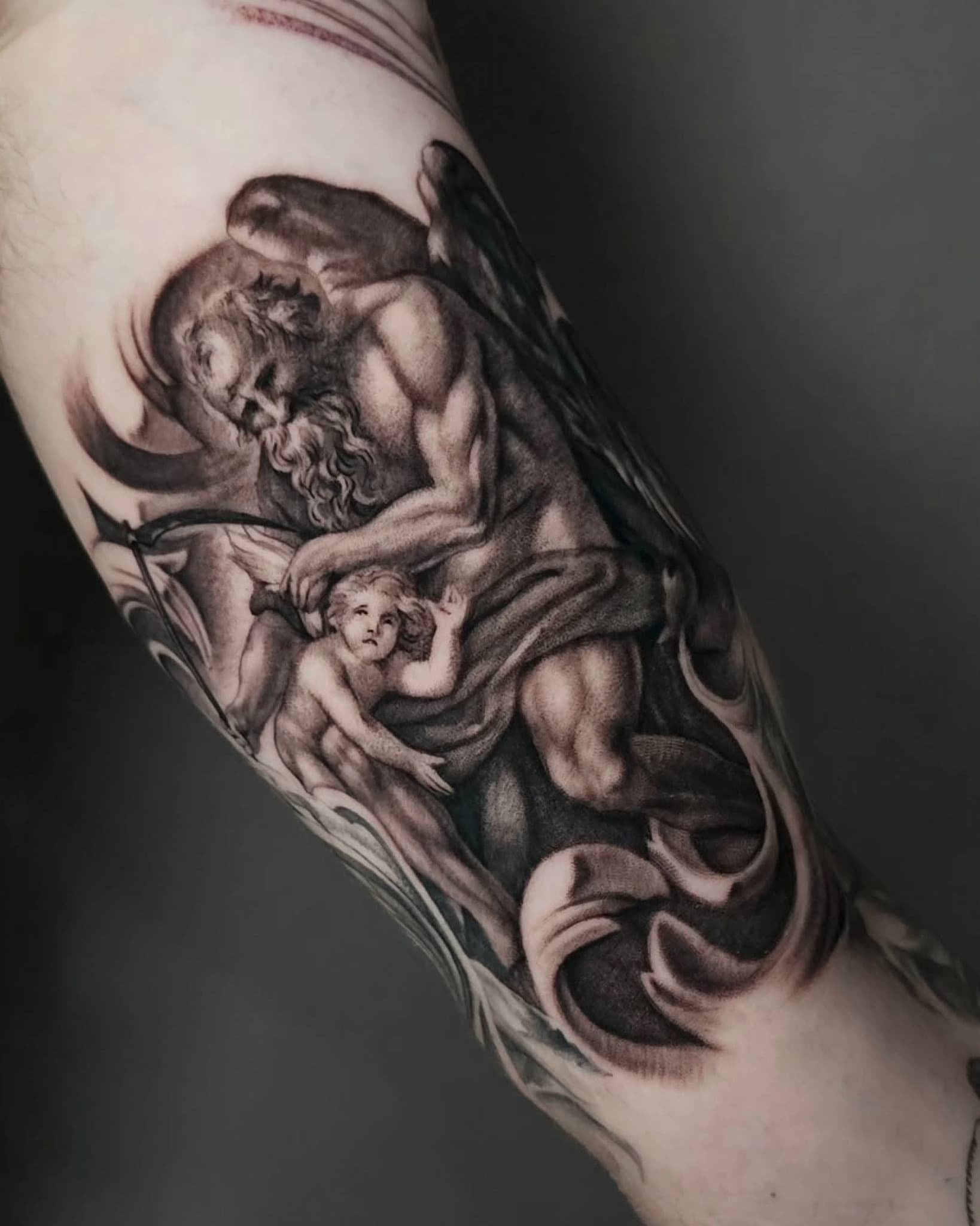 Tattoo of a classical-style angel or divine figure with wings, holding a child with detailed shading and intricate design.