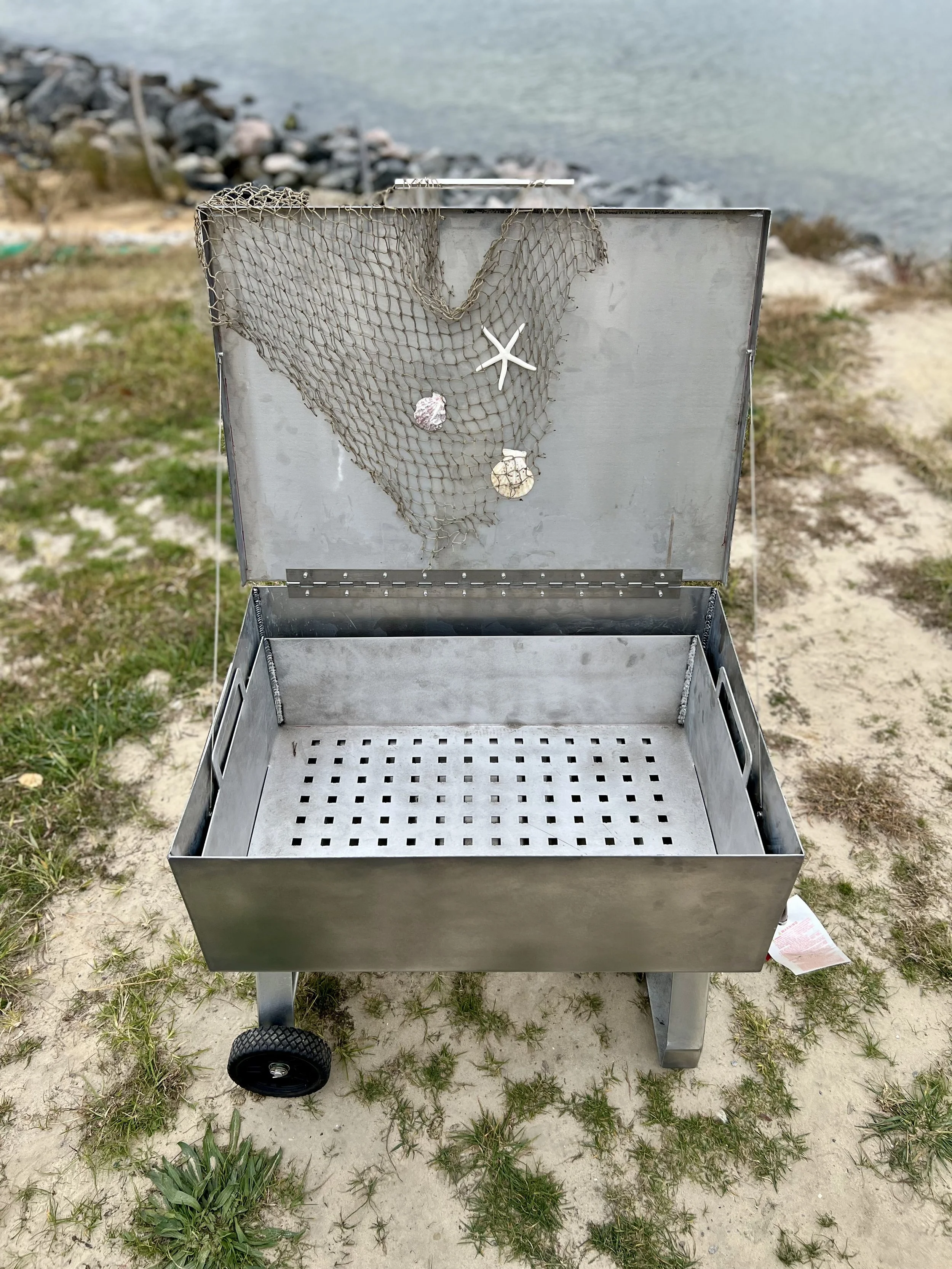 Aluminum seafood steamer with perforated tray insert for even steaming.