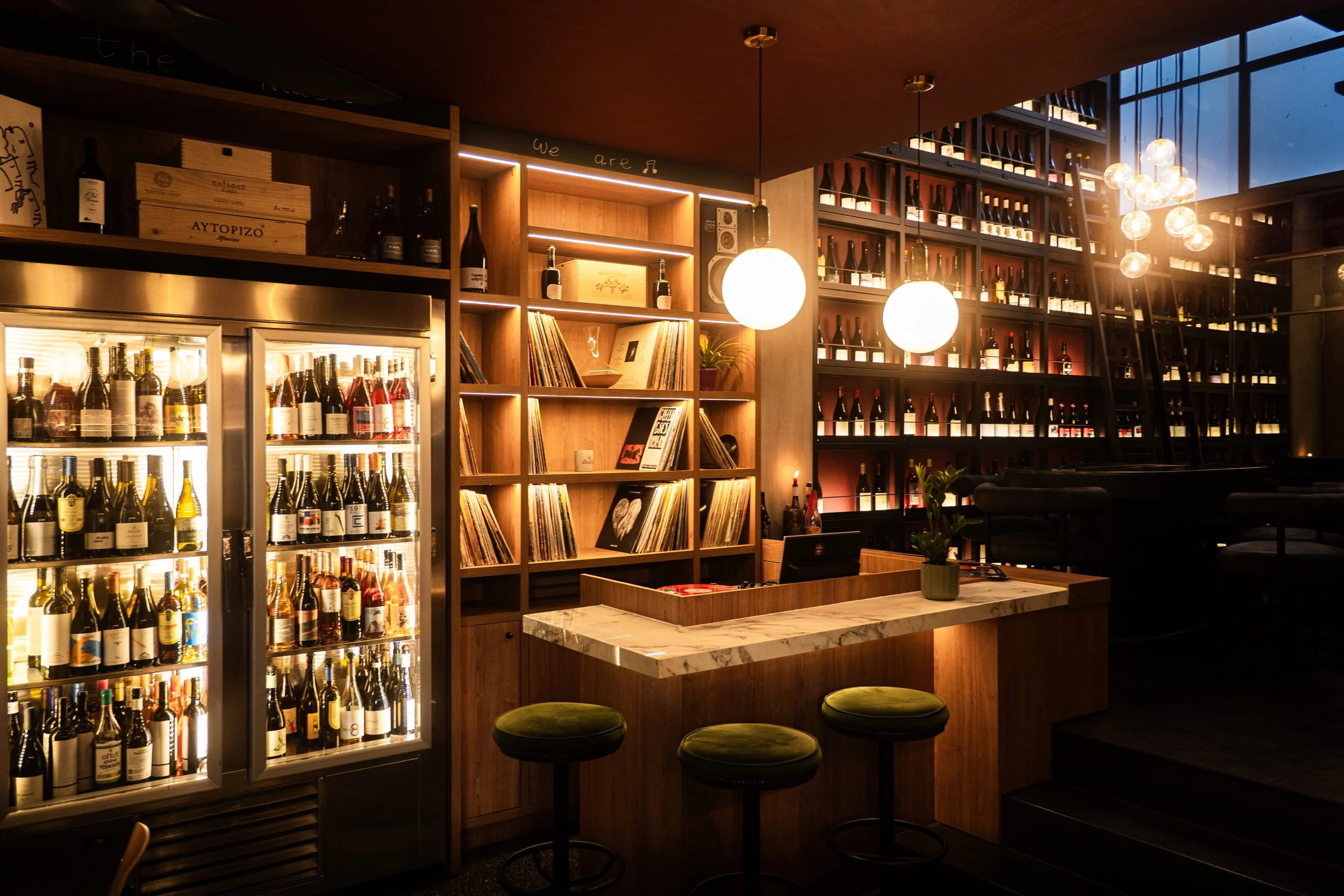 Wine cabinets, wooden shelves and seating inside Strafilo.