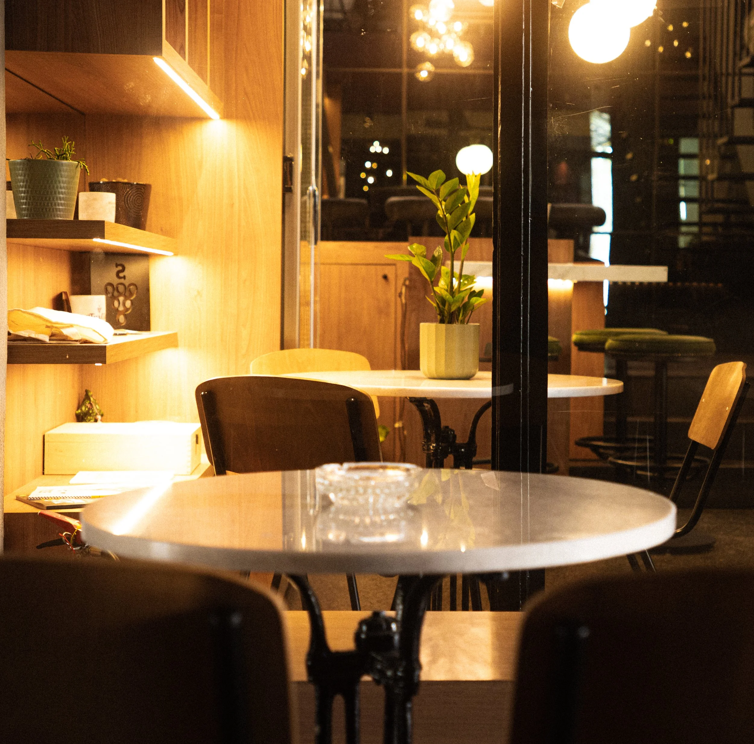 A small round table and chairs in the warmly lit bar.