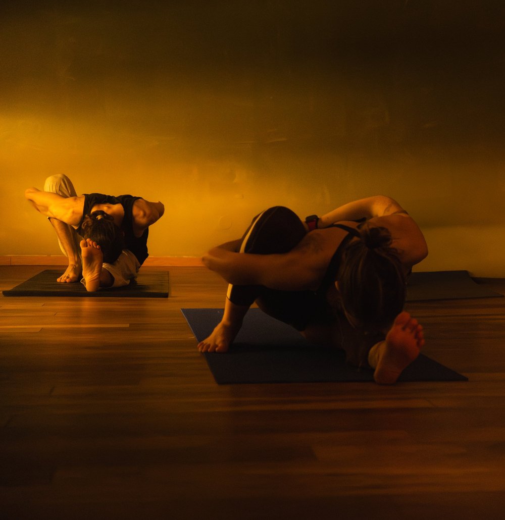 A participant holding a floor pose during a yoga session.