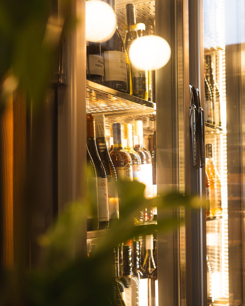 Wine glasses beside a softly lit window at Strafilo.