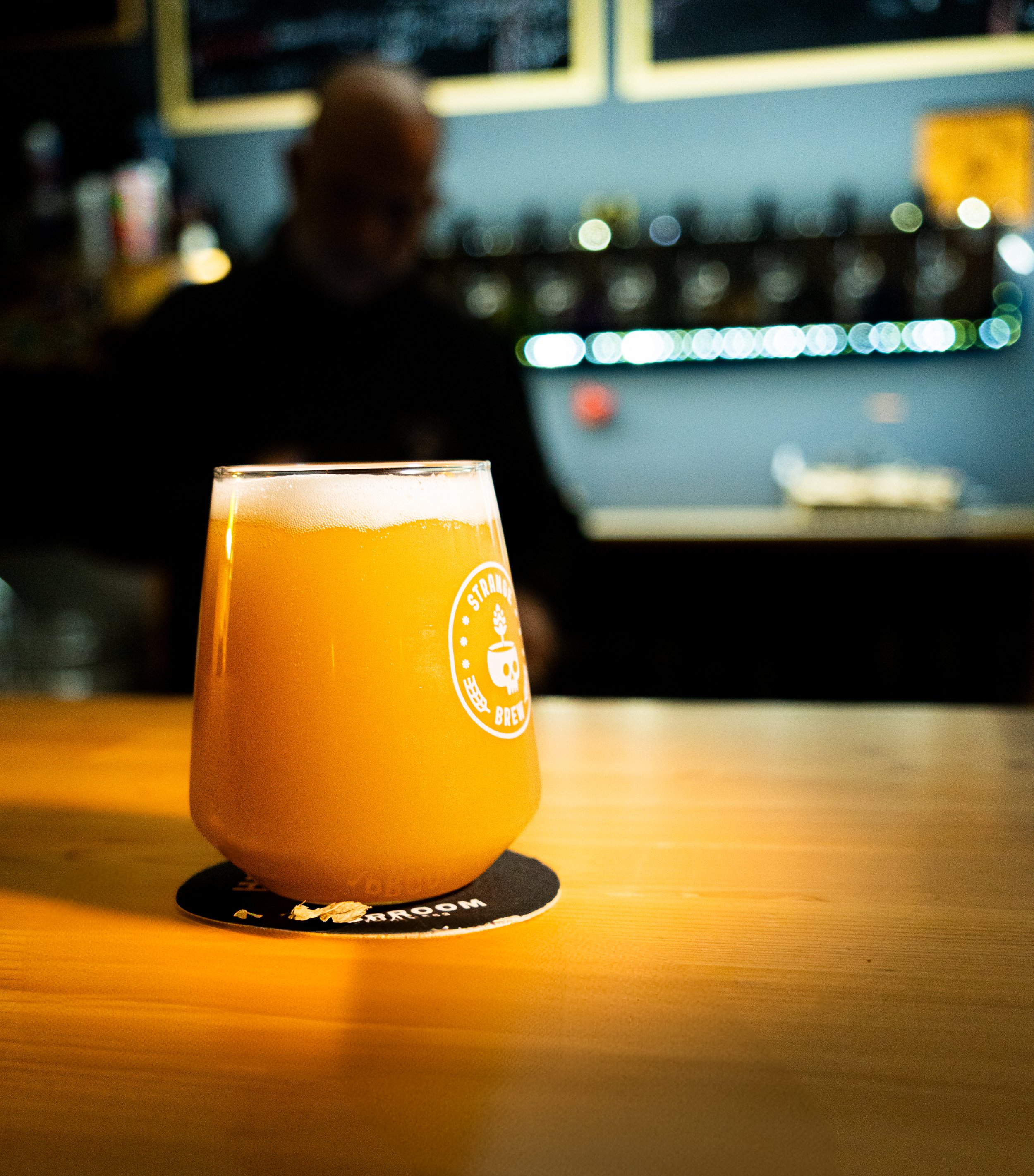 A freshly poured glass of beer on the wooden bar at High Hops.