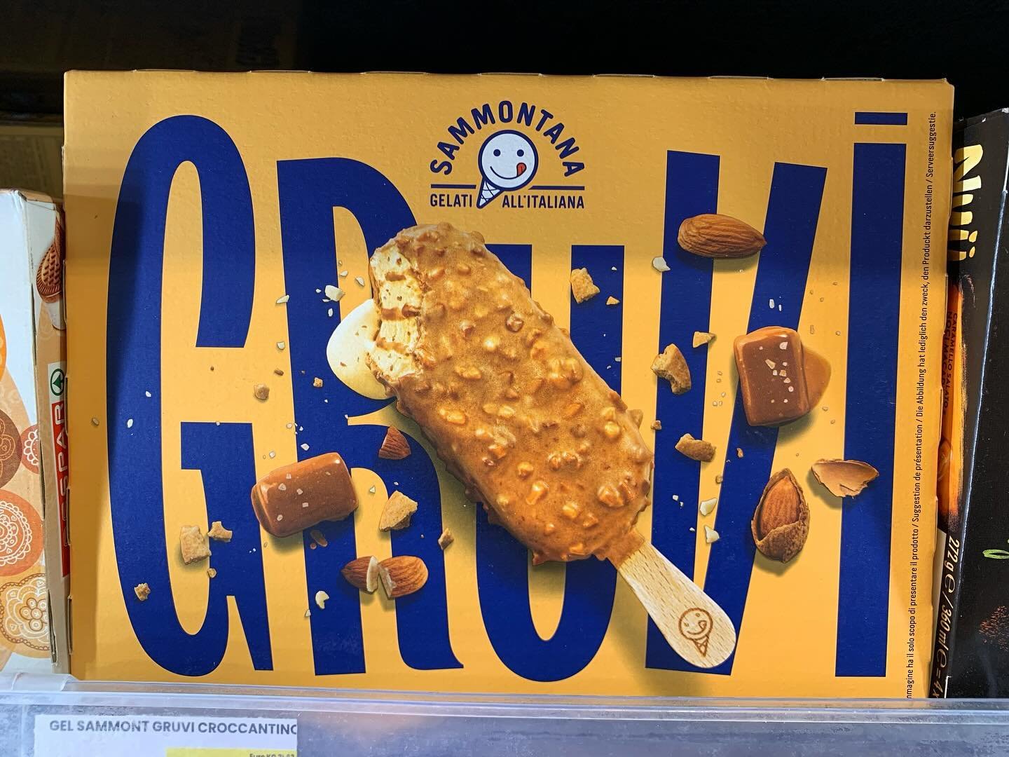 Admiring good package on the shelves of a Sardinian supermarket.