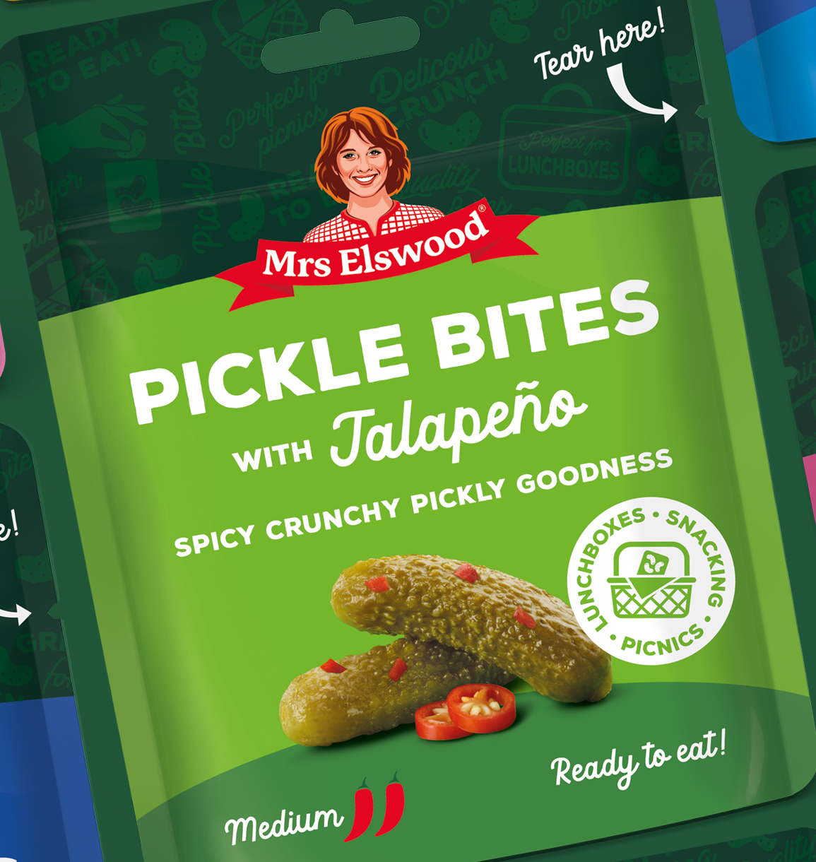 Mrs. Elswood Pickle Bites with Jalapeño packaging featuring an photo of pickles and jalapeño slices and indicating they are ready to eat, spicy, crunchy, and suitable for lunchboxes, snacks, and picnics.