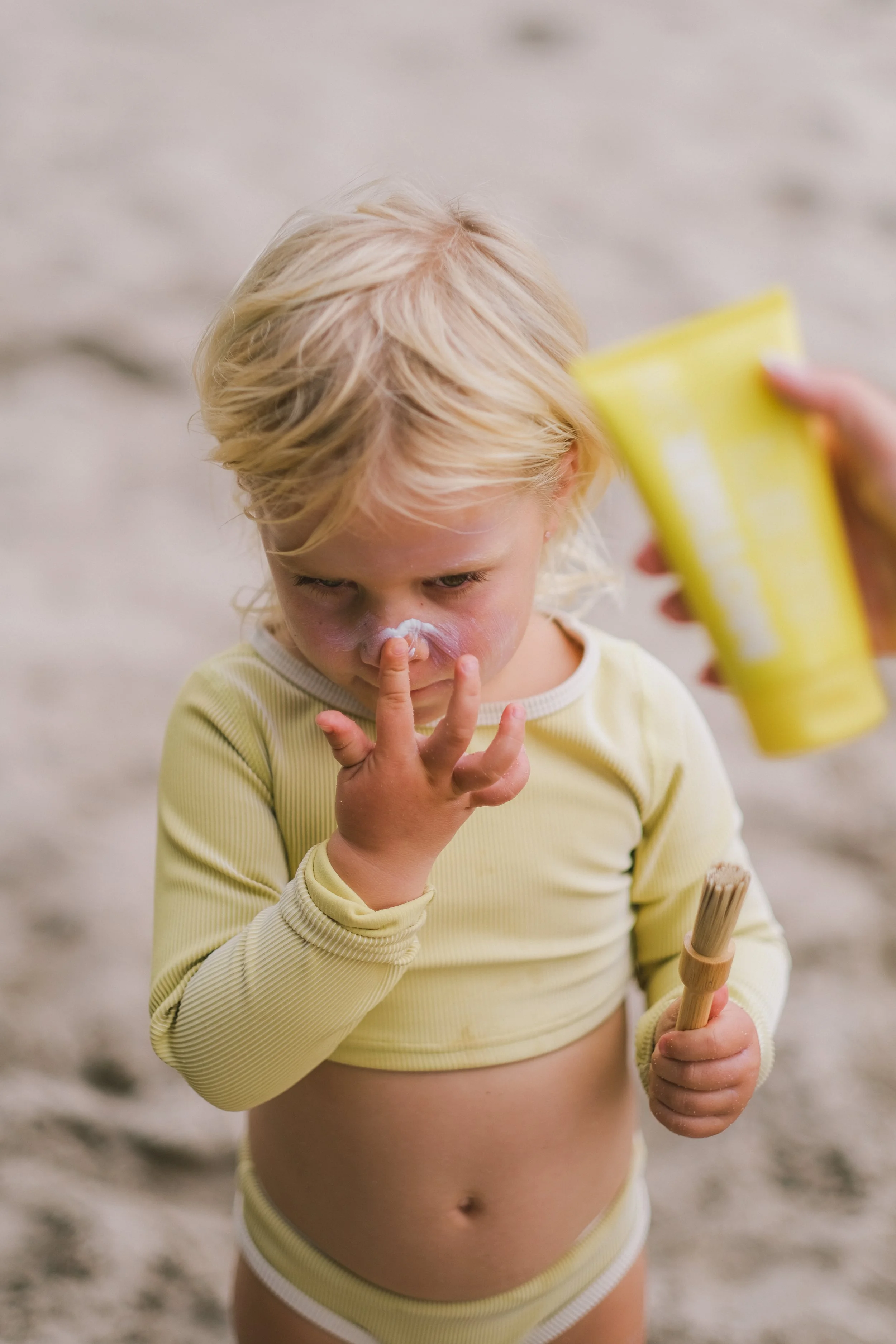 photo of little girl applying mother spf.jpg