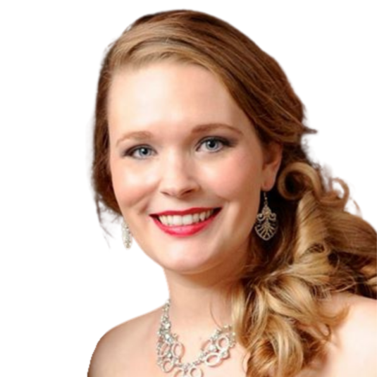 Diana Nugent wearing a purple strapless dress, silver earrings, and necklace, with curled hair, smiling.