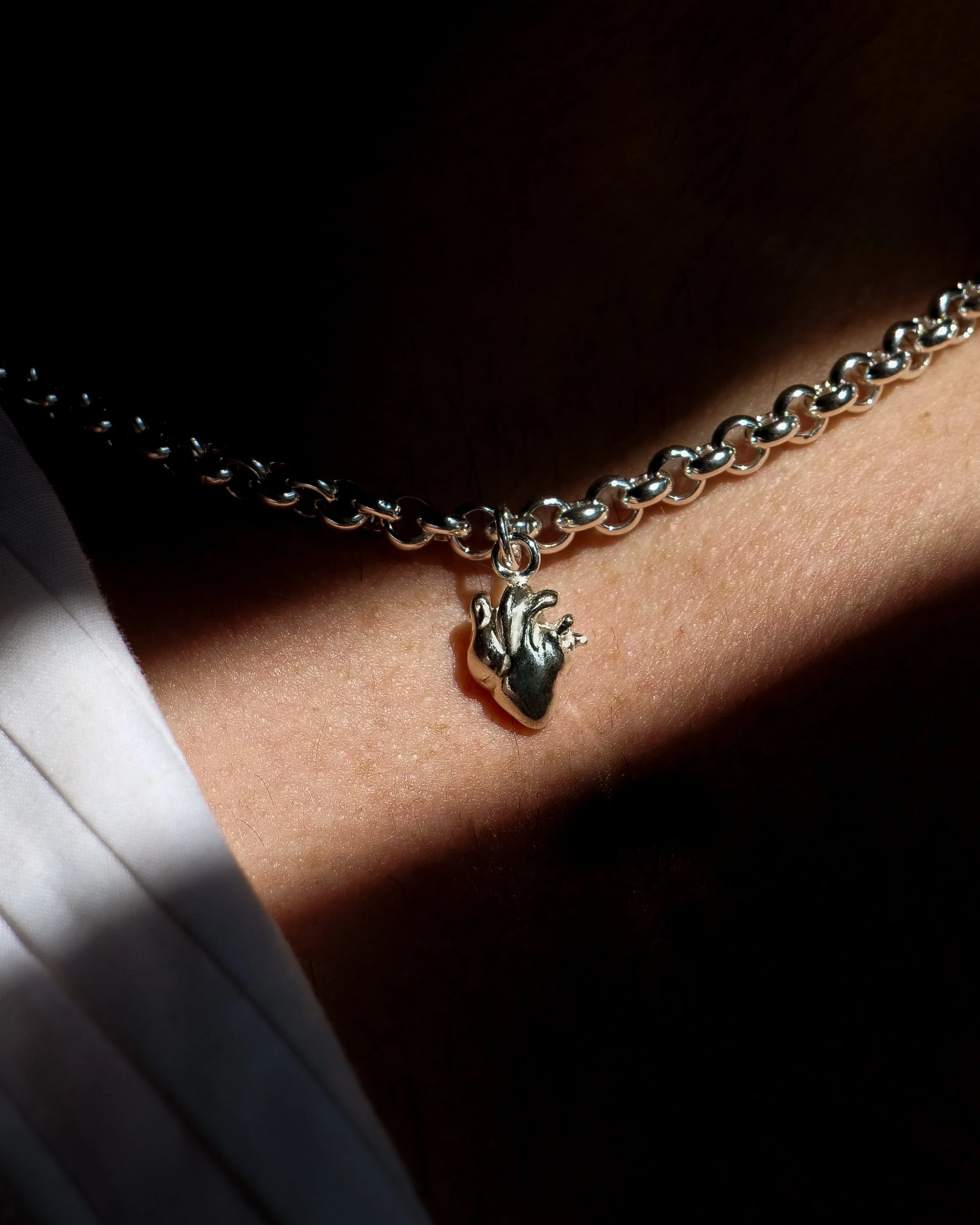 A hand-sculpted sterling silver anatomical heart necklace