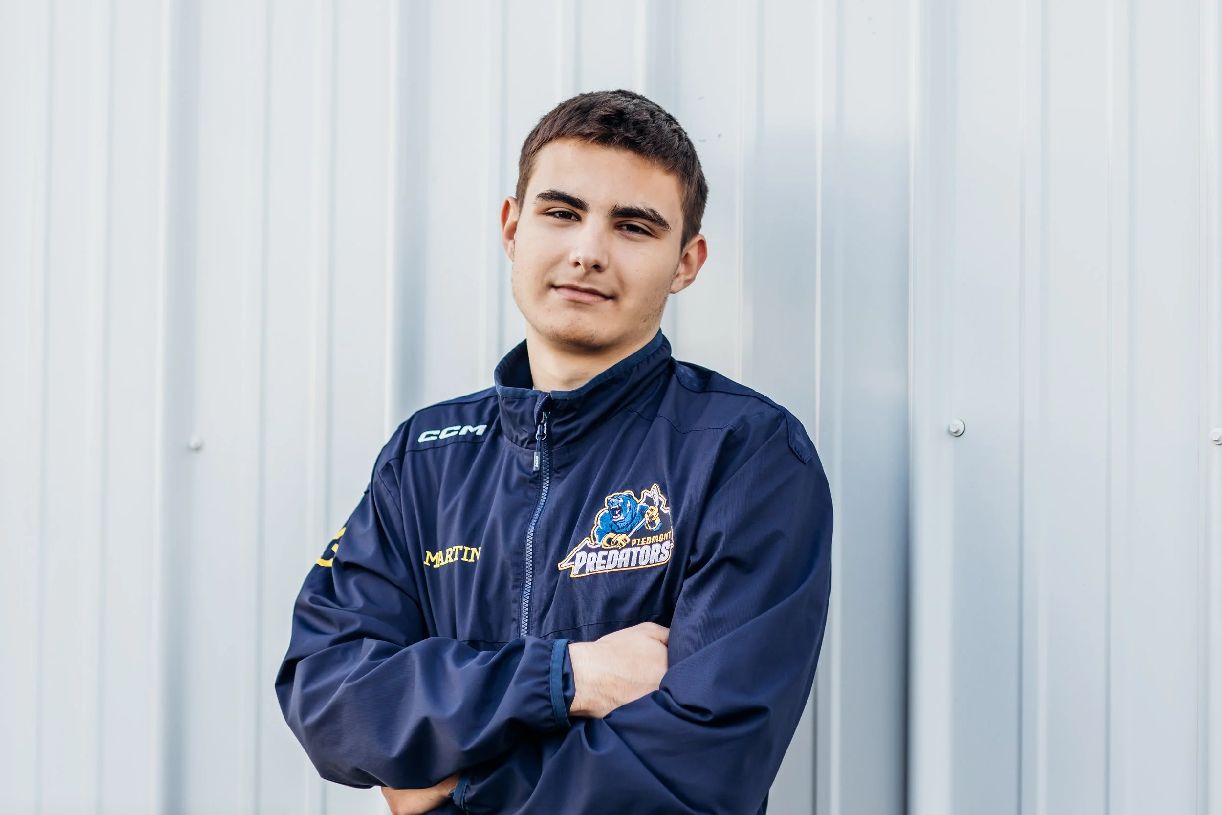 hockey player leaning against metal building