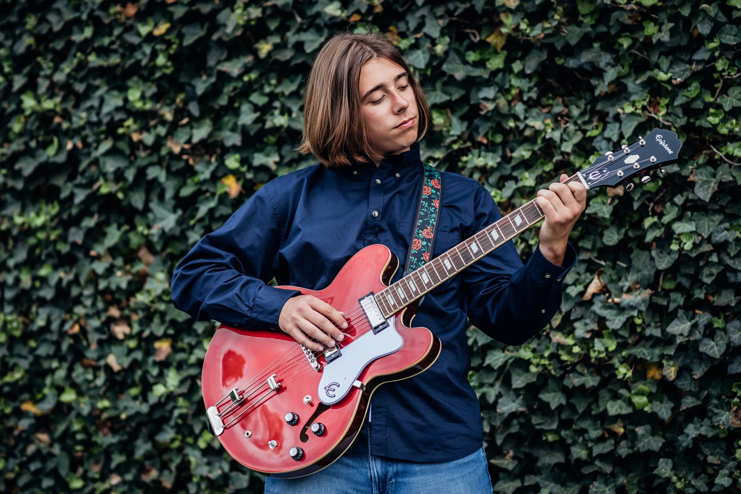High School Senior playing guitar near Bristow VA taken by local photographer.