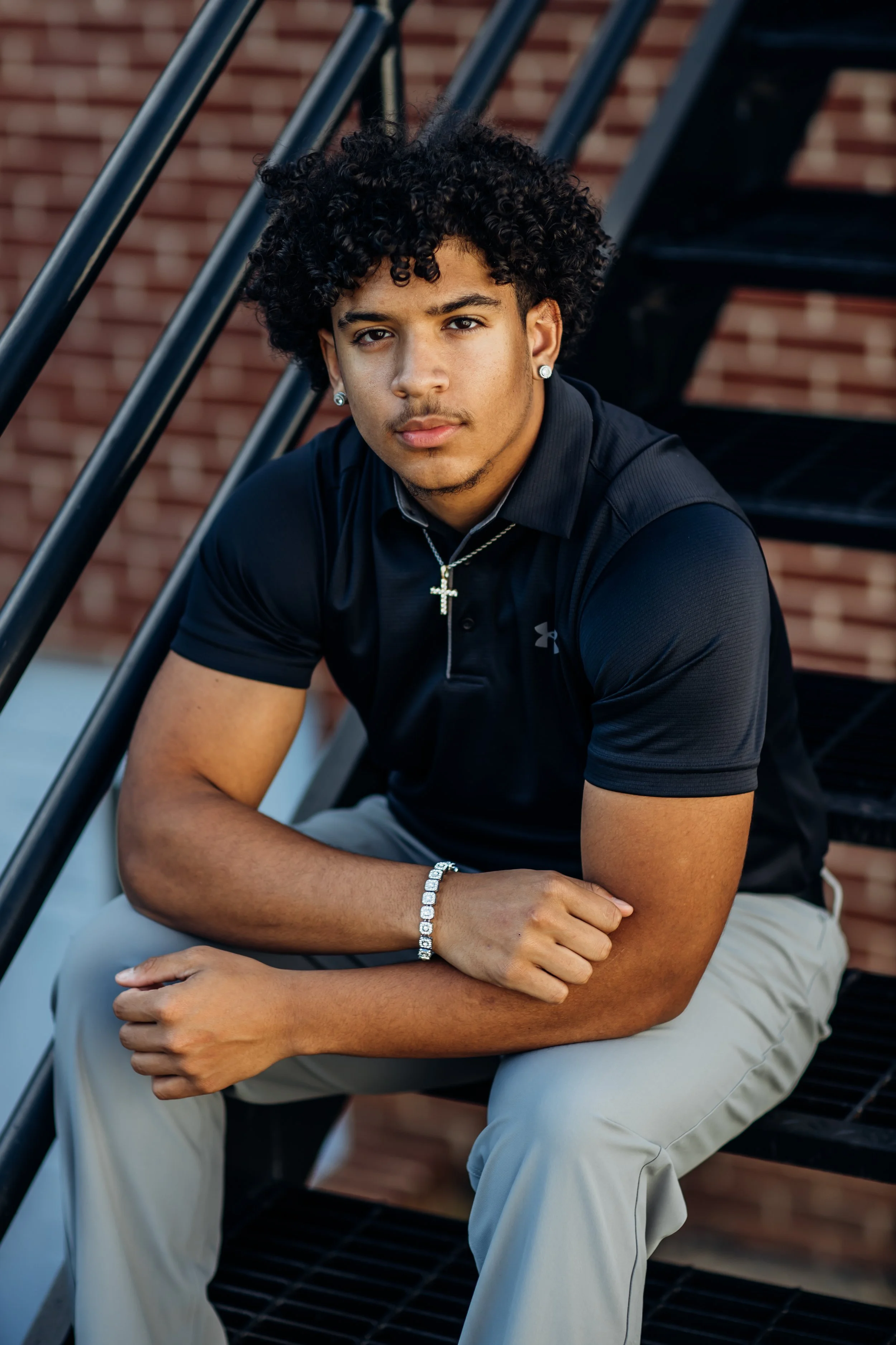 High School Senior posing on stairs for his senior pictures with local photographer in Haymarket VA Virginia