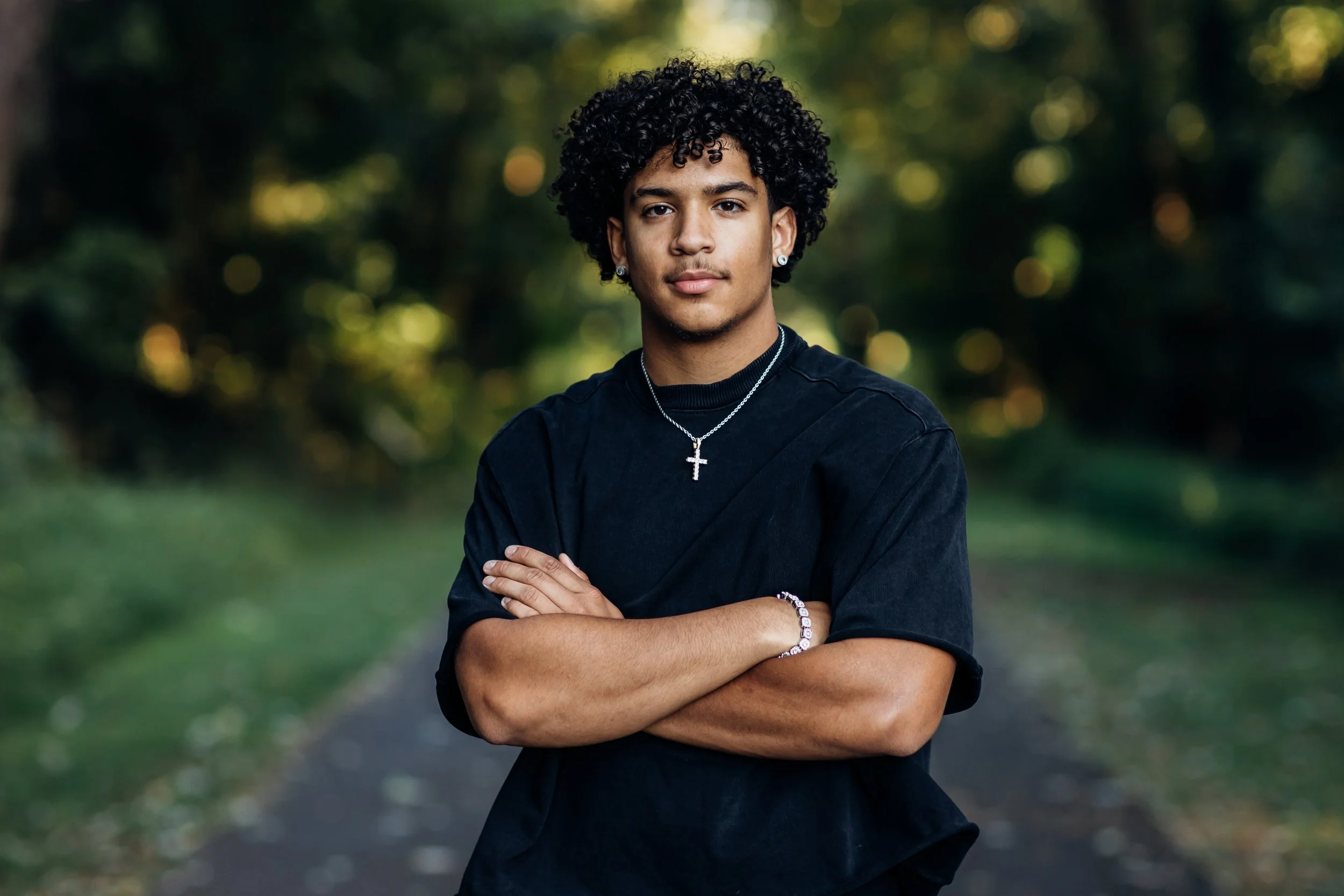 High School Senior posing for picture with arms crossed in Northern Virginia trail