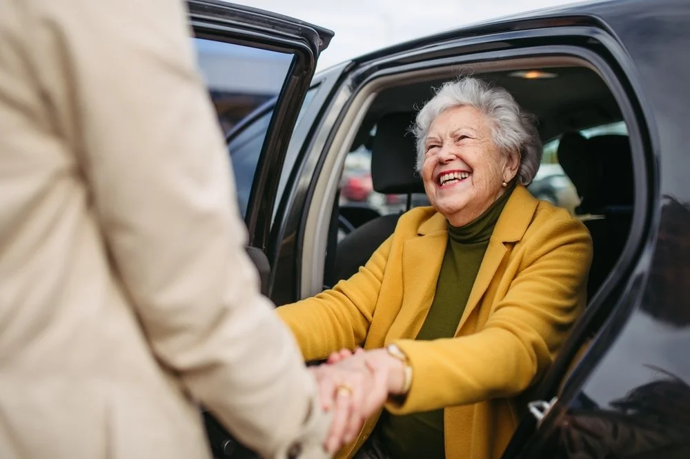 Specialist professional chaperone support for elderly wedding guest assisting out of Quahquai with confidence and dignity