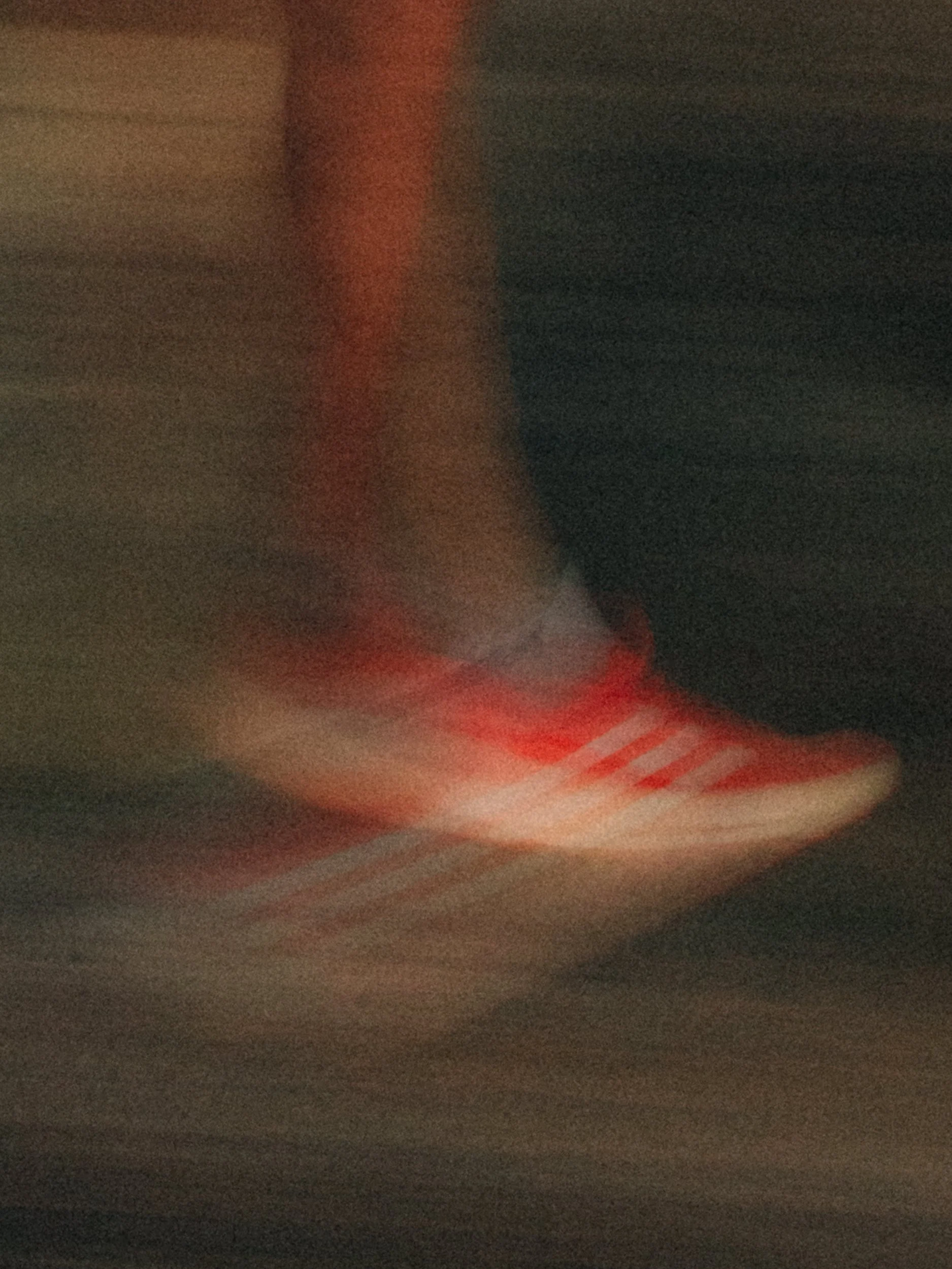 Blurred red and white sneaker in motion