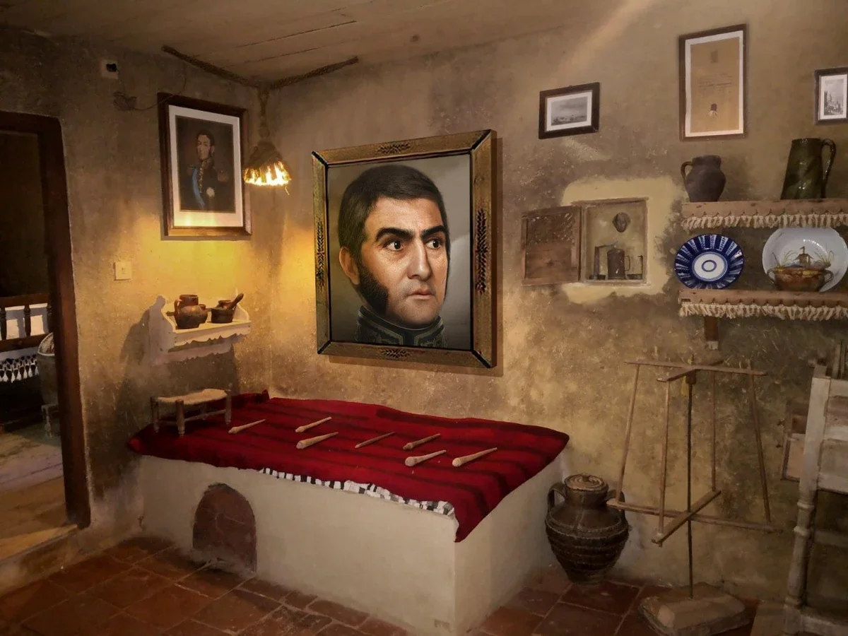 A European-style building with three flags: the French flag, the Russian flag, and another flag, above an entrance with a sign on the side reading 'Optique'.